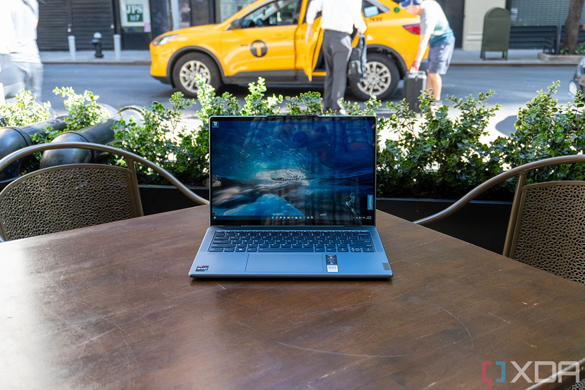 Laptop on wooden table with taxi in the background