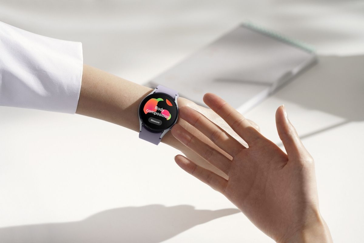 A person taking Body Composition measurement on their Galaxy Watch 5 by touching the side of the watch using their fingers
