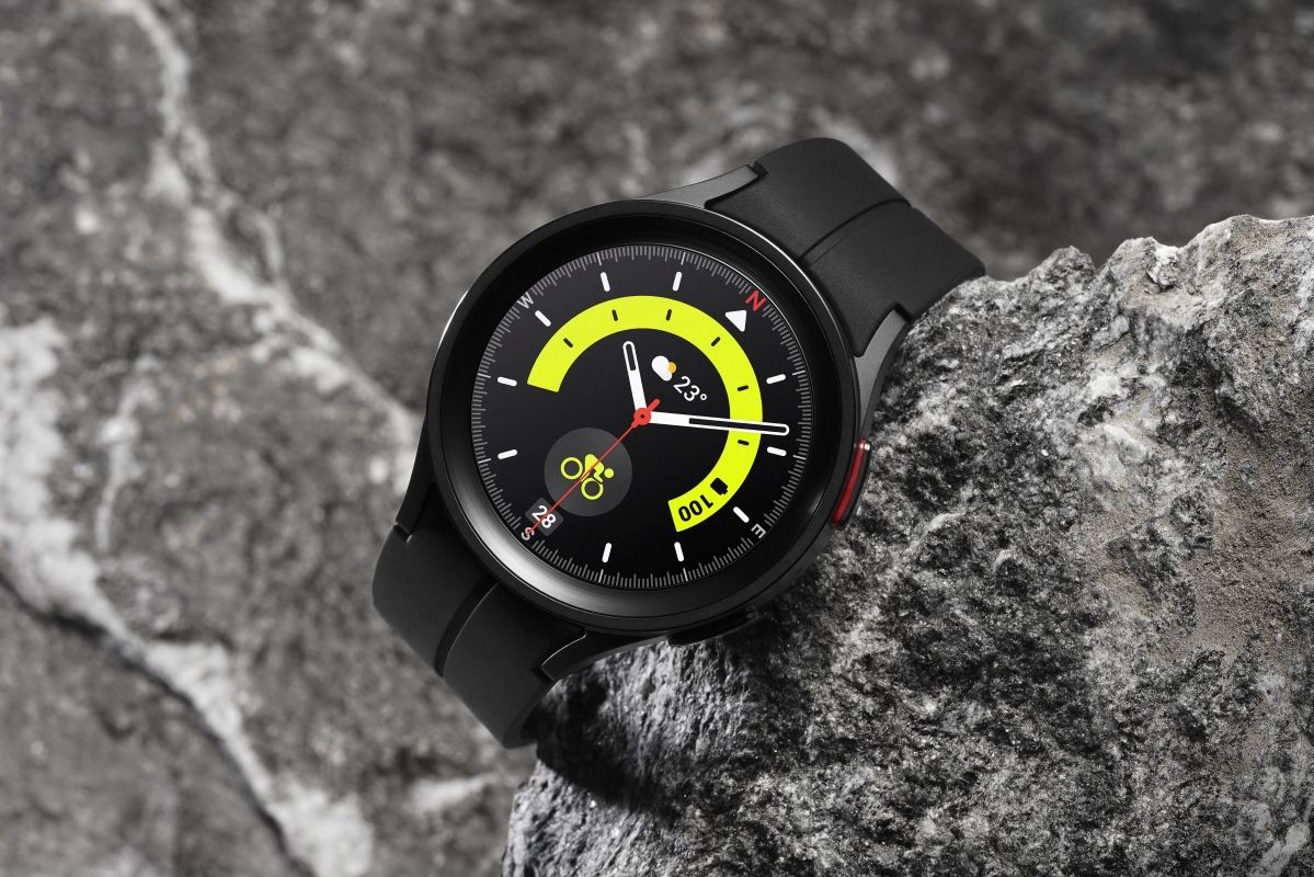 Black Samsung Galaxy Watch 4 Pro placed on rocks.