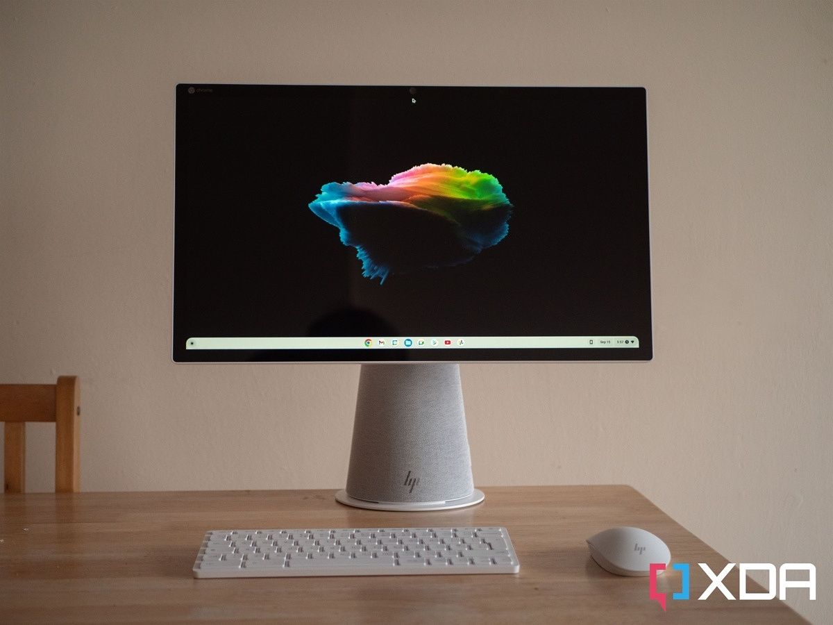 HP Chromebase All-in-One on a table, with the mouse and keyboard in front of it