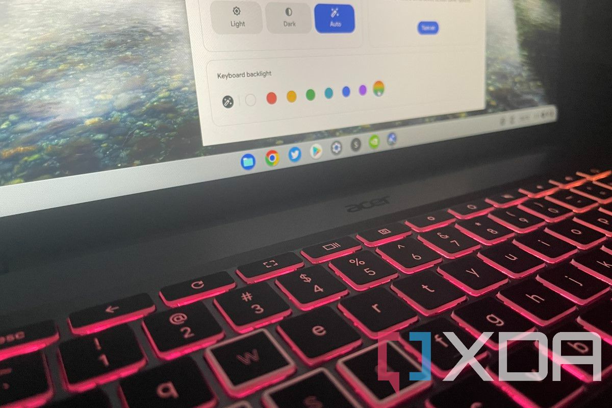 Close-up of the Acer Chromebook 516 GE's RGB keyboard lit up in pink.