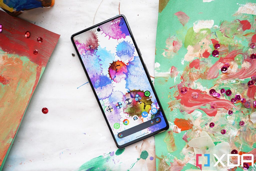 A Pixel 7 surrounded by paint and glitter