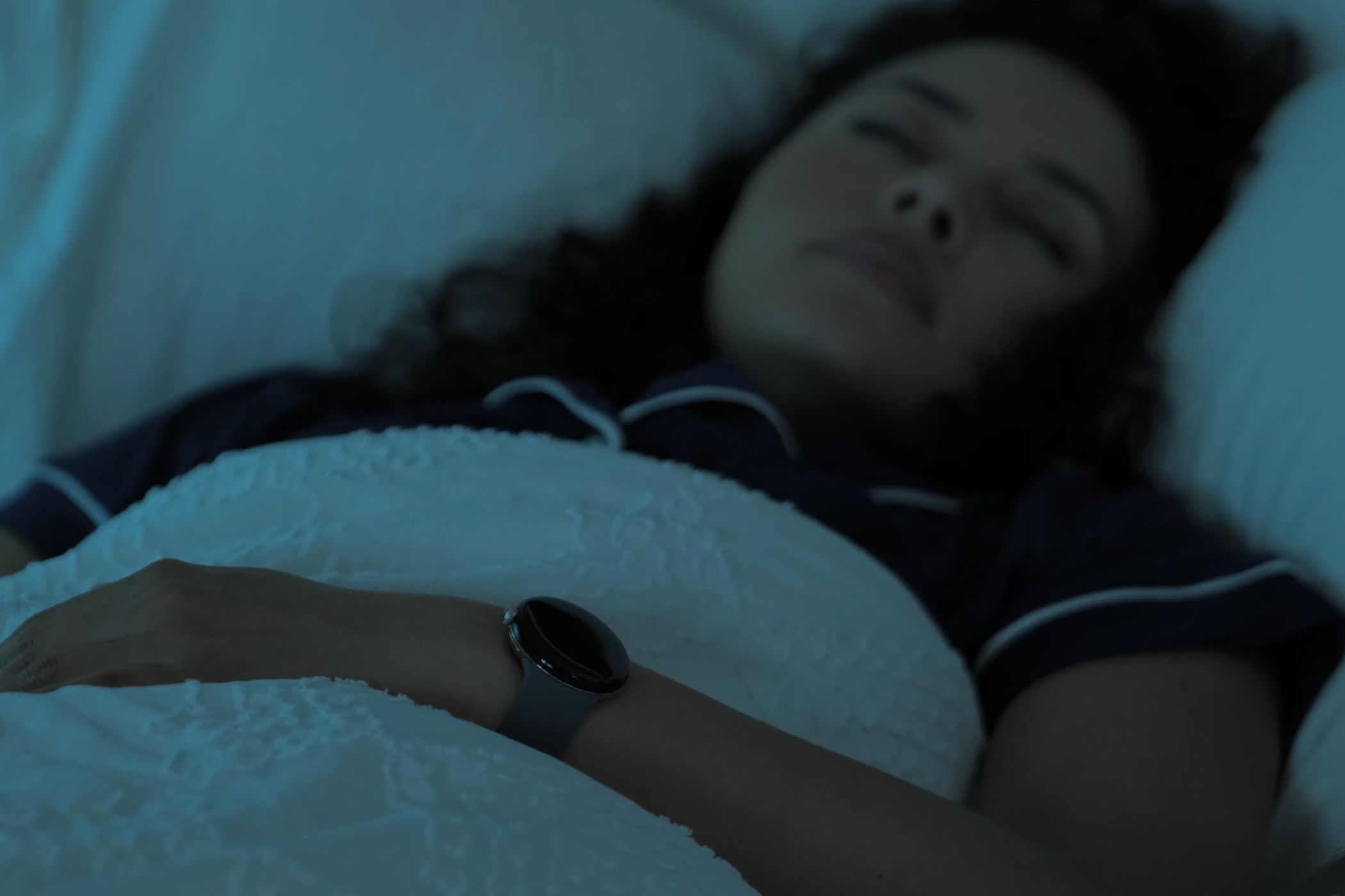Person wearing the Google Pixel Watch to sleep.