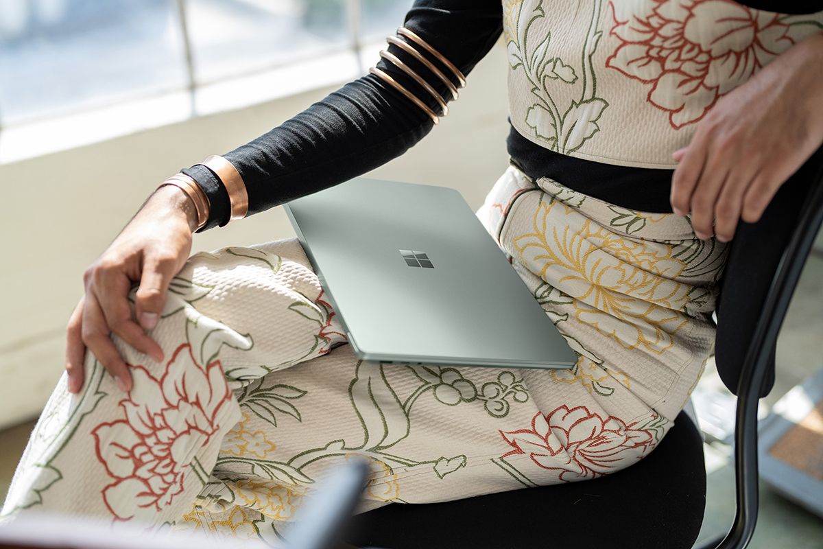 Surface Laptop 5 in Sage colorway on a woman's lap