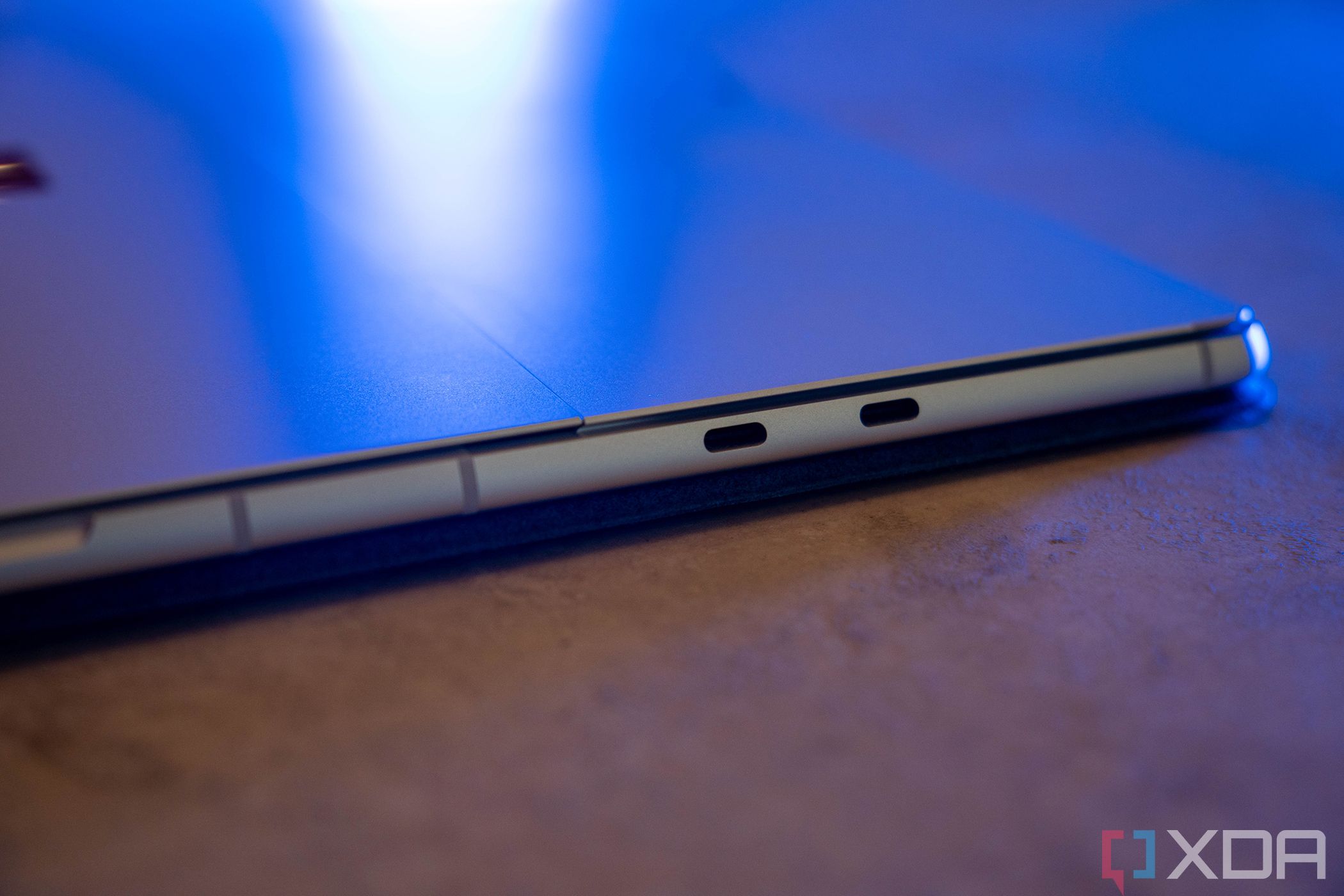Dual USB Type-C ports on the side of a silver tablet with blue lighting