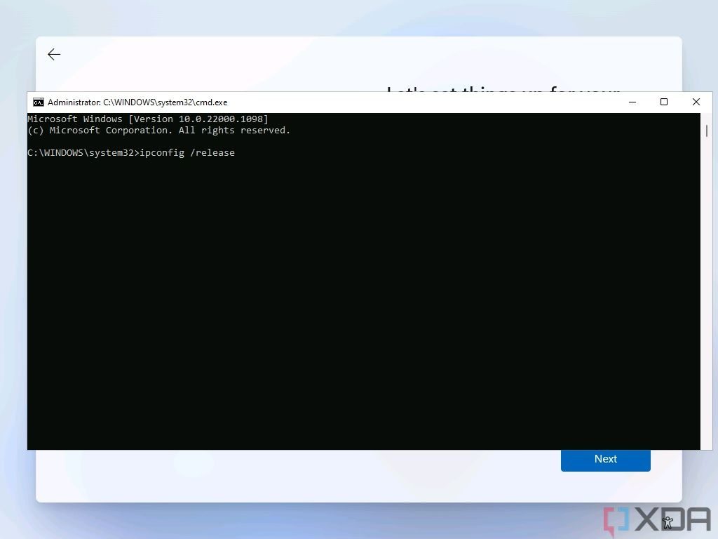Screenshot of Command Prompt open over the Windows 11 setup experience with the command to disable the internet connection