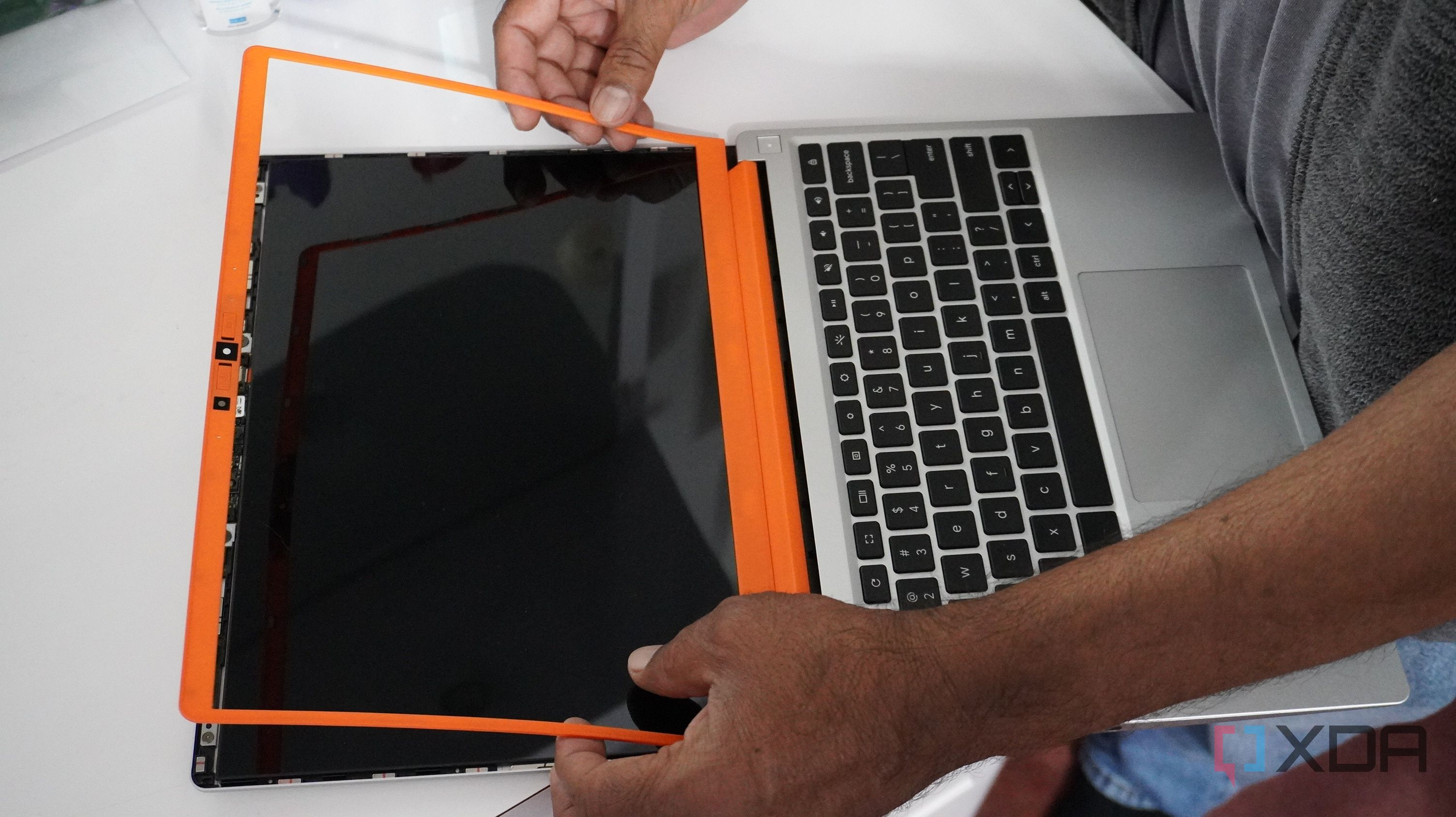 A man replacing the bezels on the Framework Chromebook.