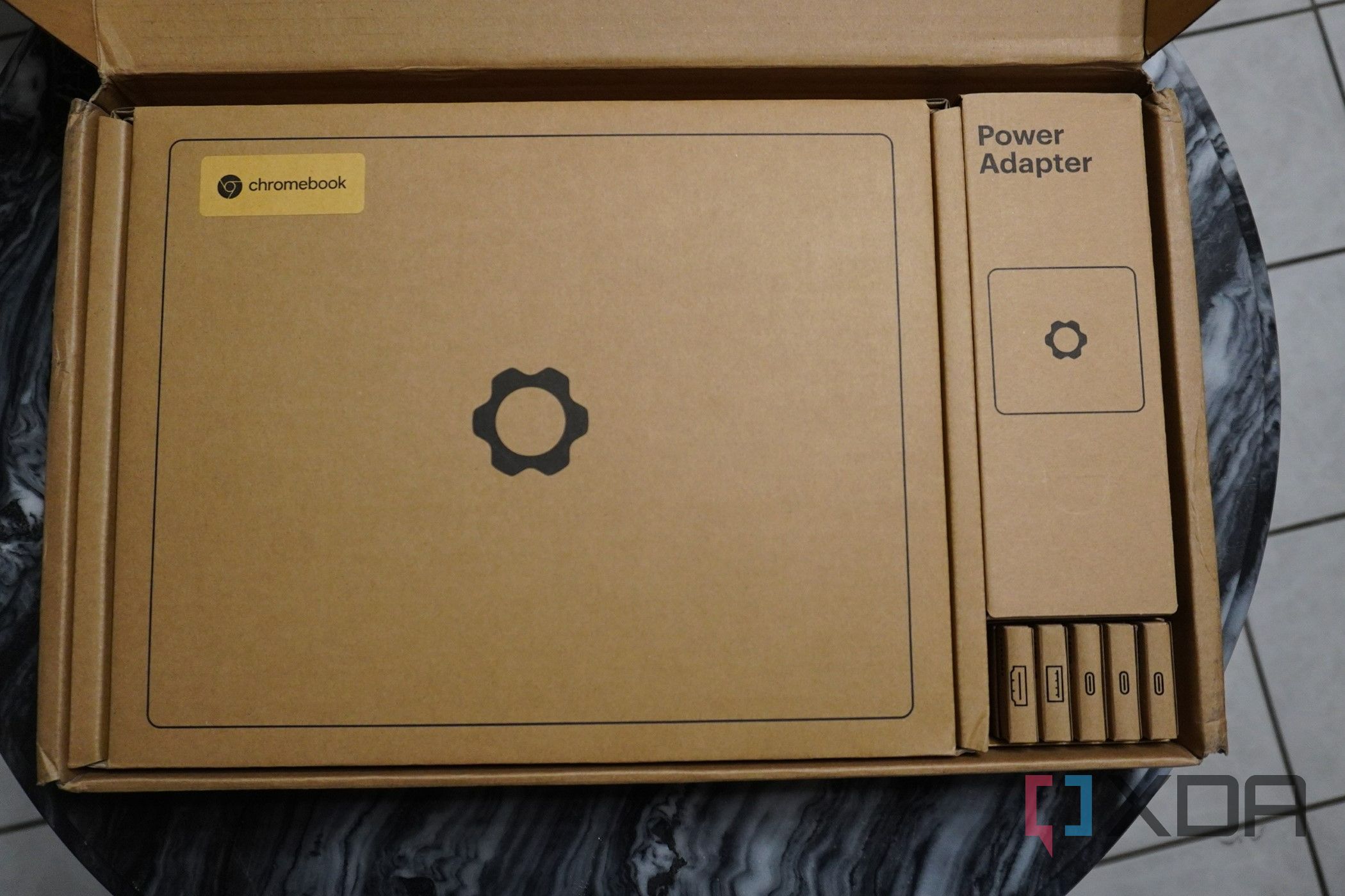 The retail box of the Framework Chromebook, with lid open.