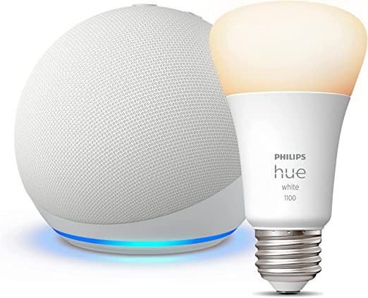 White Echo Dot 5th Gen with a Philips Hue bulb on a white background.