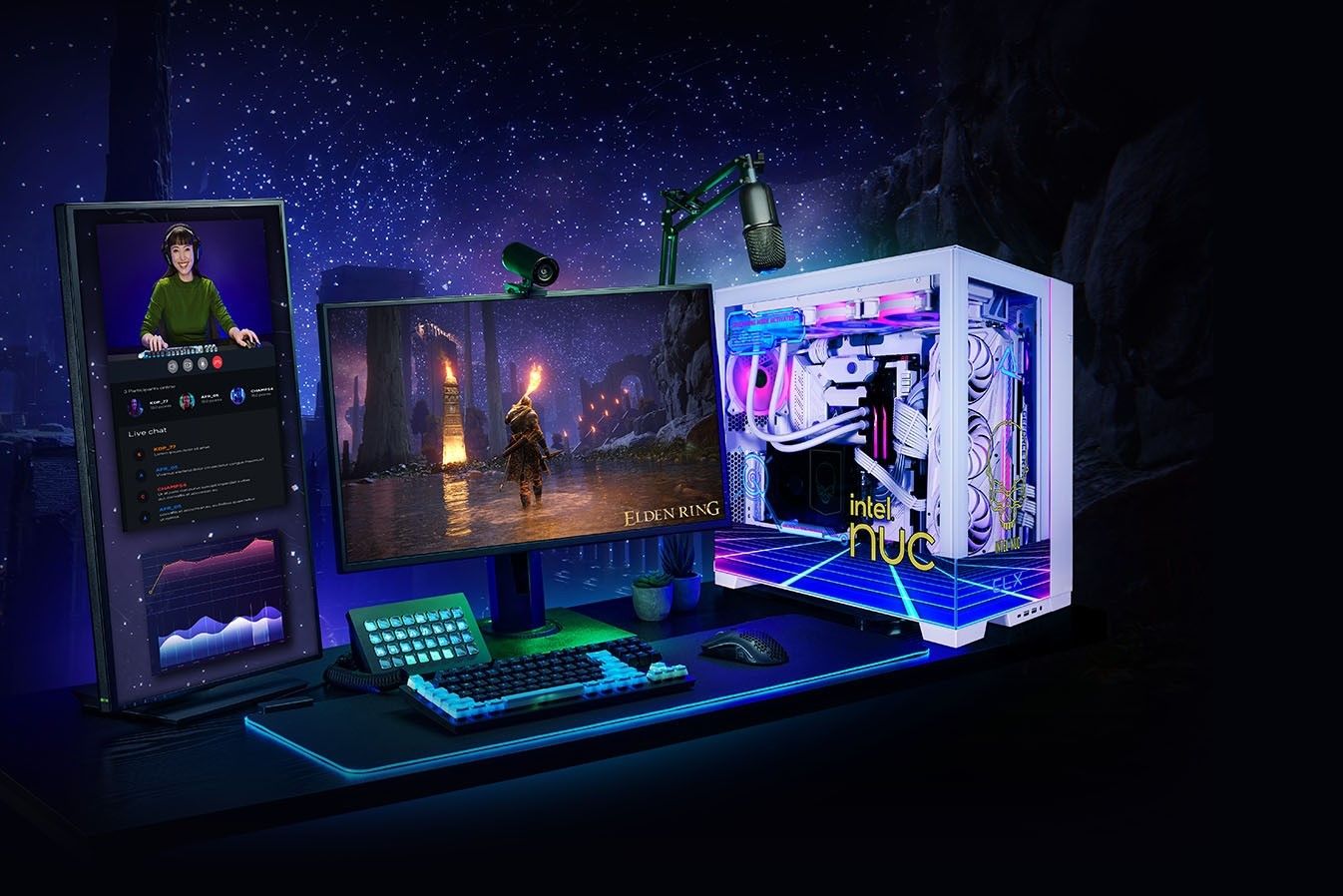 A CLX Hathor gaming desktop alongside various peripherals including two monitors, one of which is vertical, plus a keyboard, mouse, microphone and webcam.