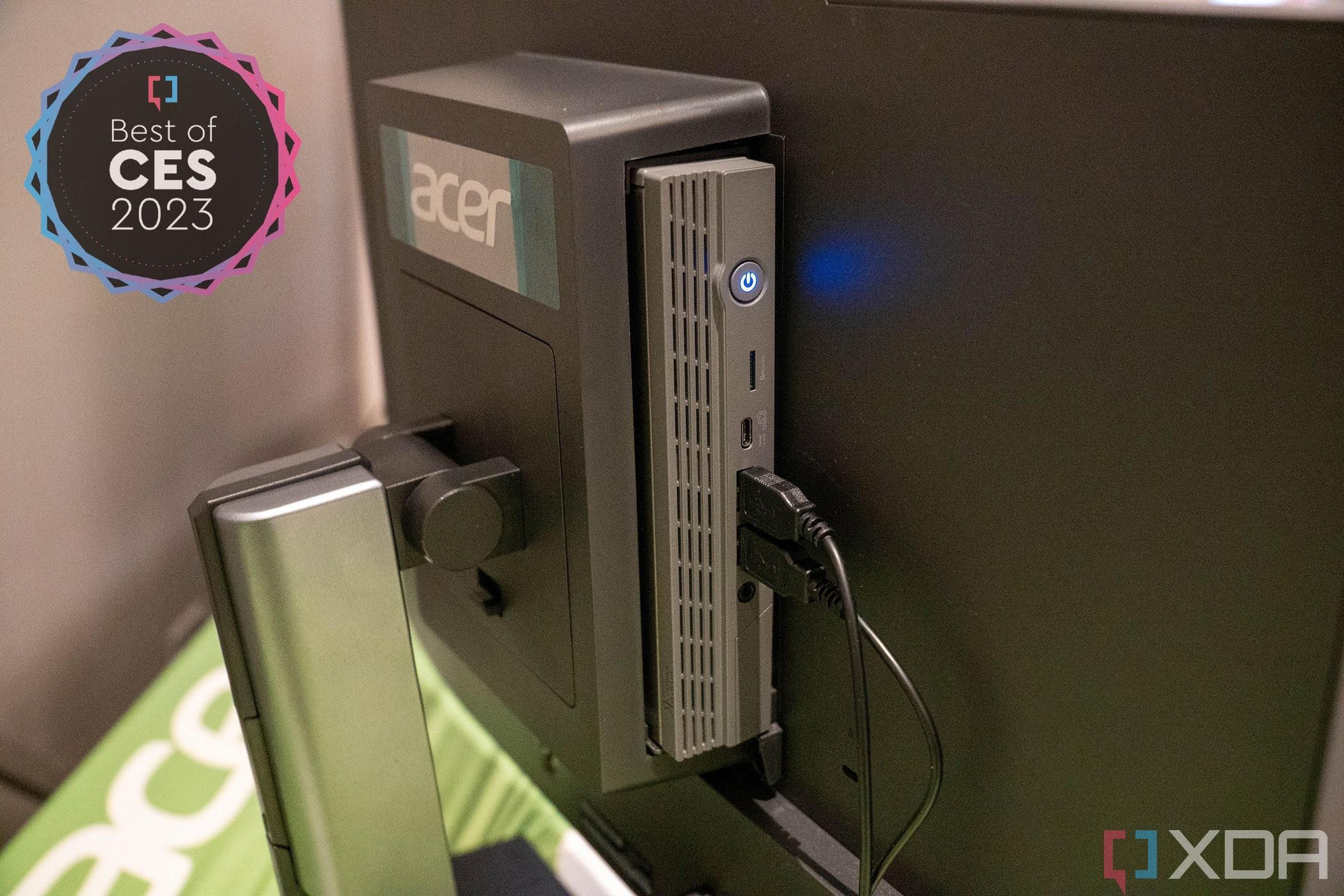 Rear angled view of the Acer Chromebox Add-in-One system, with an Acer Chromebox CXI5 installed on the back of a monitor. The top left corner of the image has a badge reading 