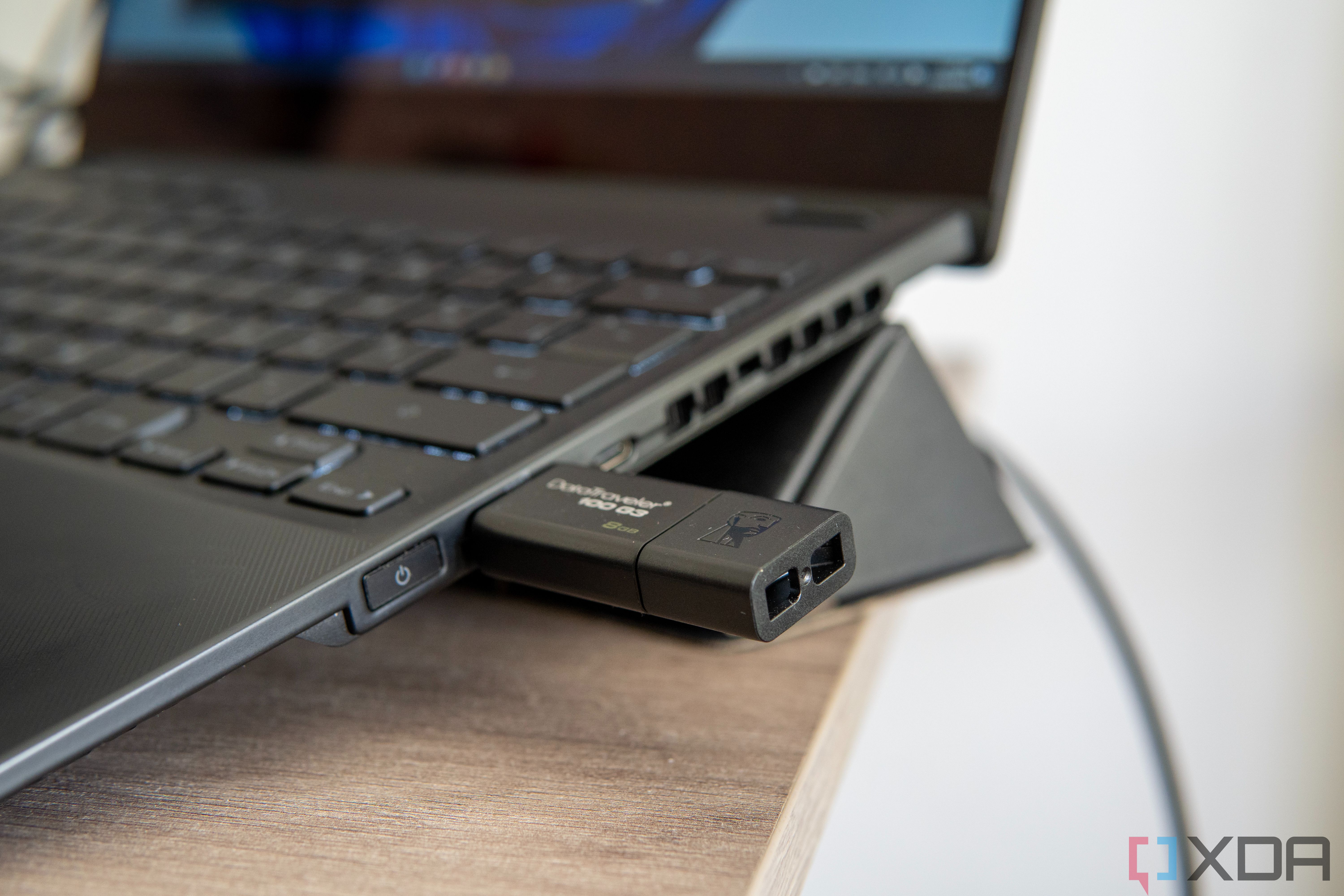 Close-up view of a USB flash drive connected to a Windows 11 laptop