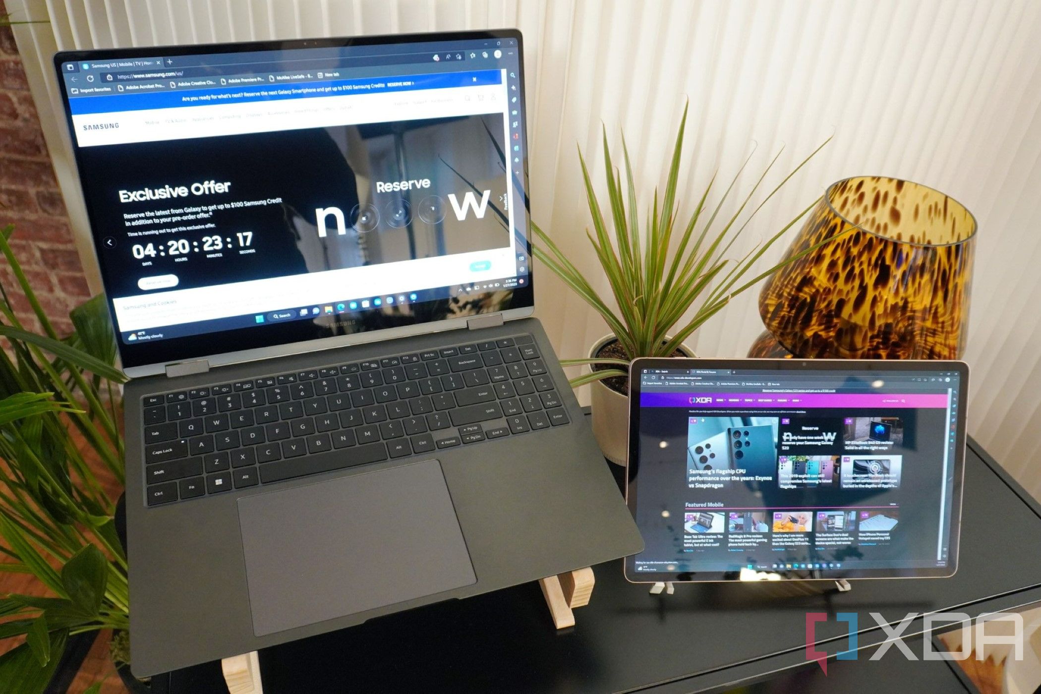 The Galaxy Book 3 Pro 360 sitting on a desk with a tablet.