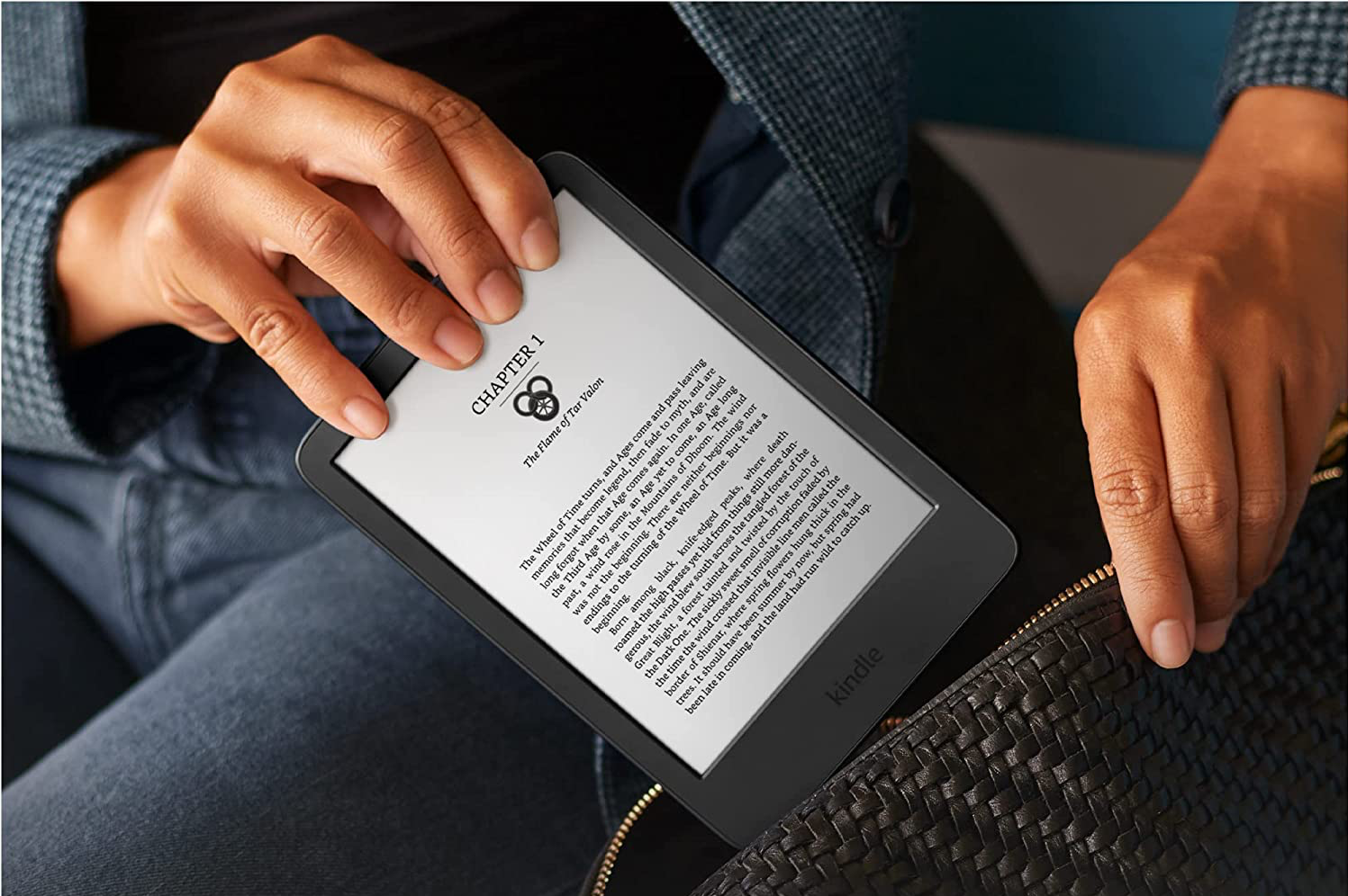 A person sliding the Kindle 11th Gen in a bag