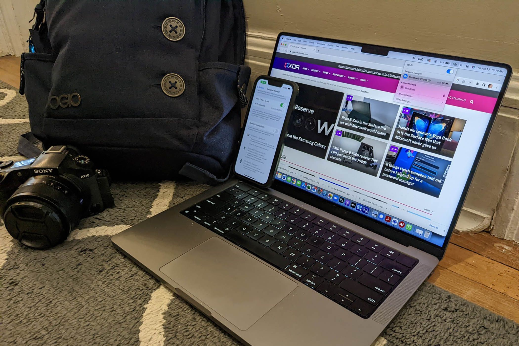 MacBook with iPhone, backpack and camera.