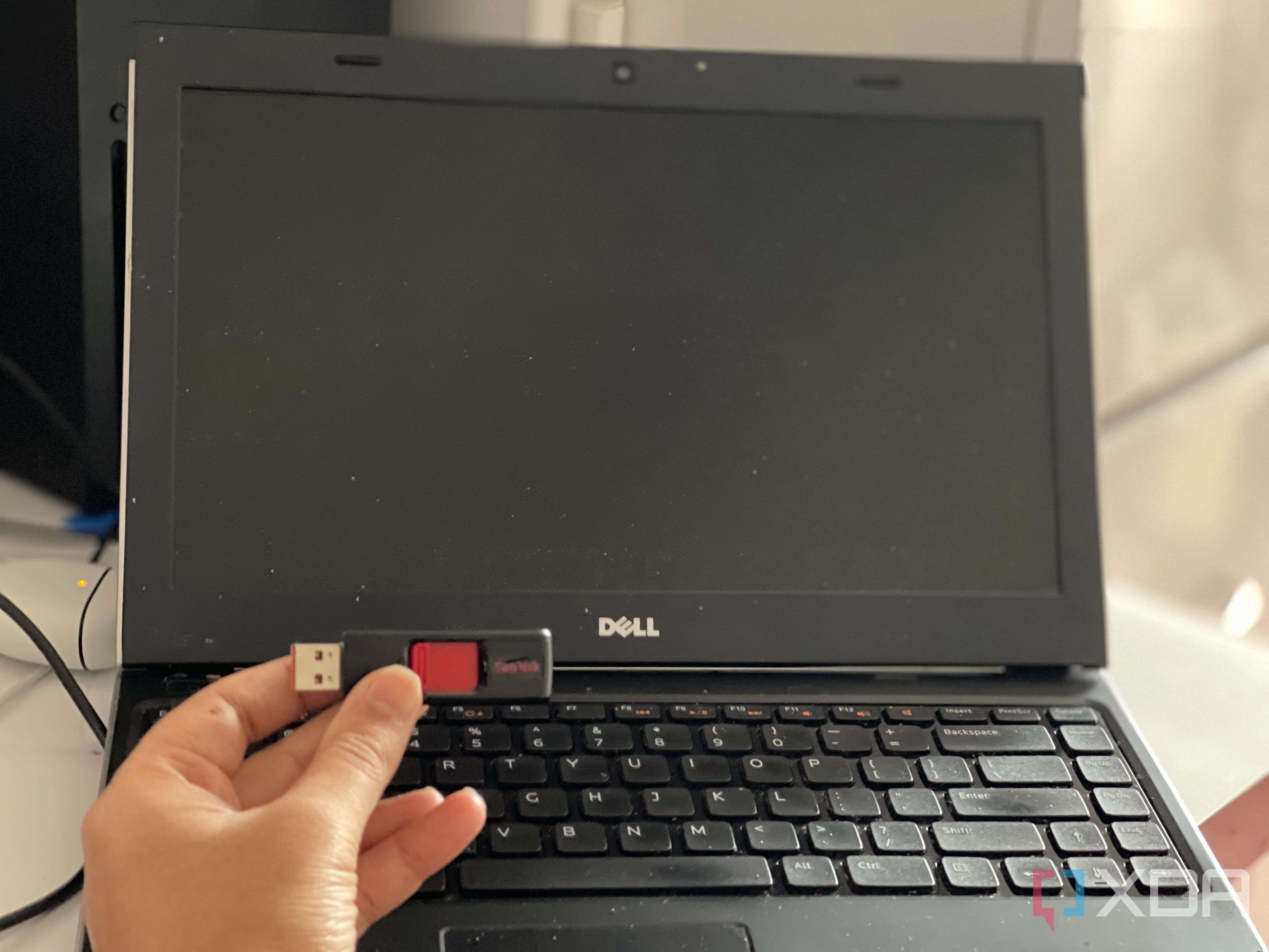 A Dell laptop with a USB drive