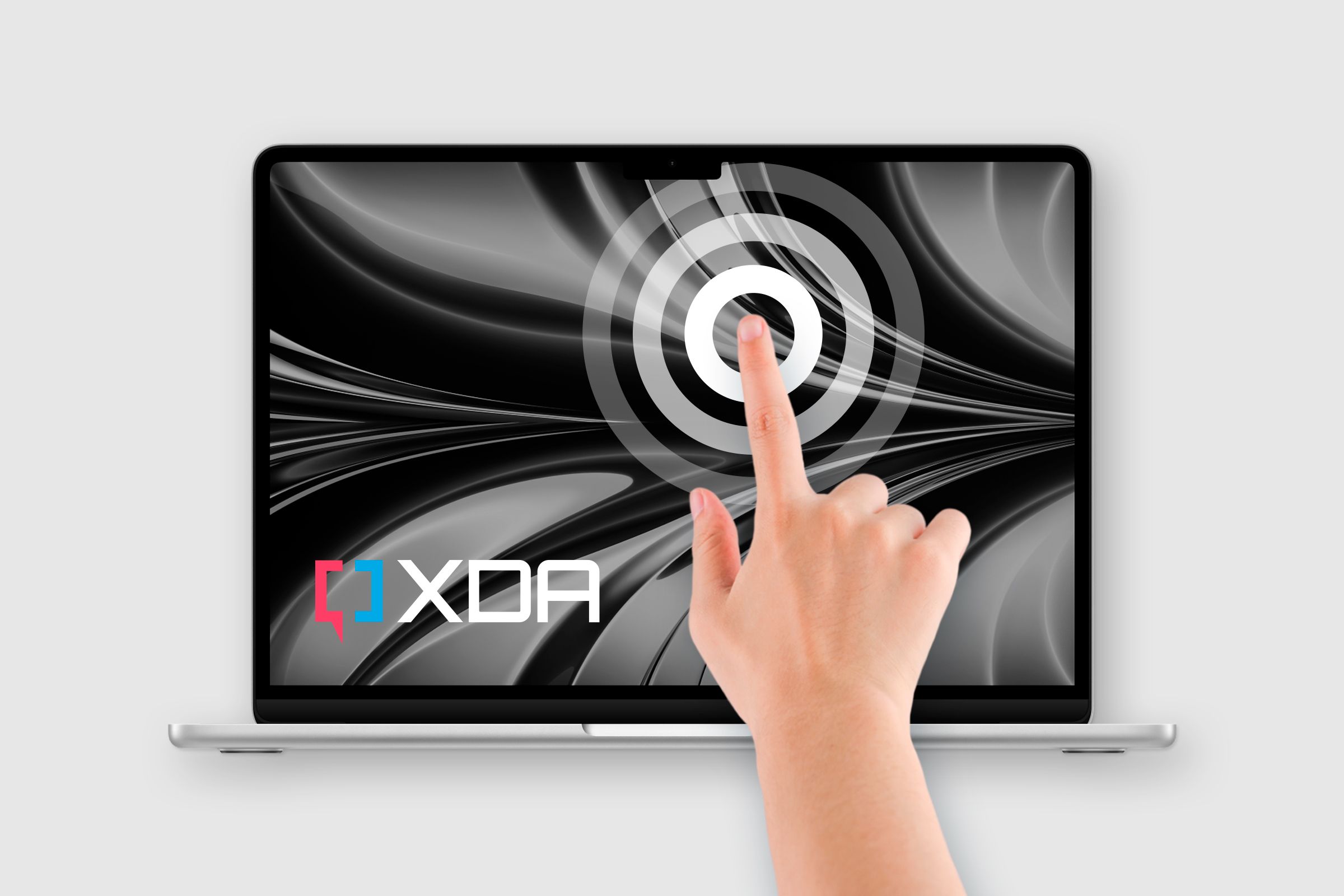 hand touching the Touchscreen MacBook featuring XDA logo onscreen