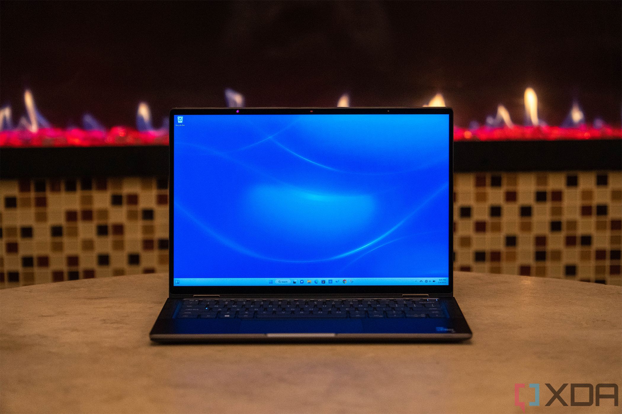 Front view of laptop in front of red fireplace