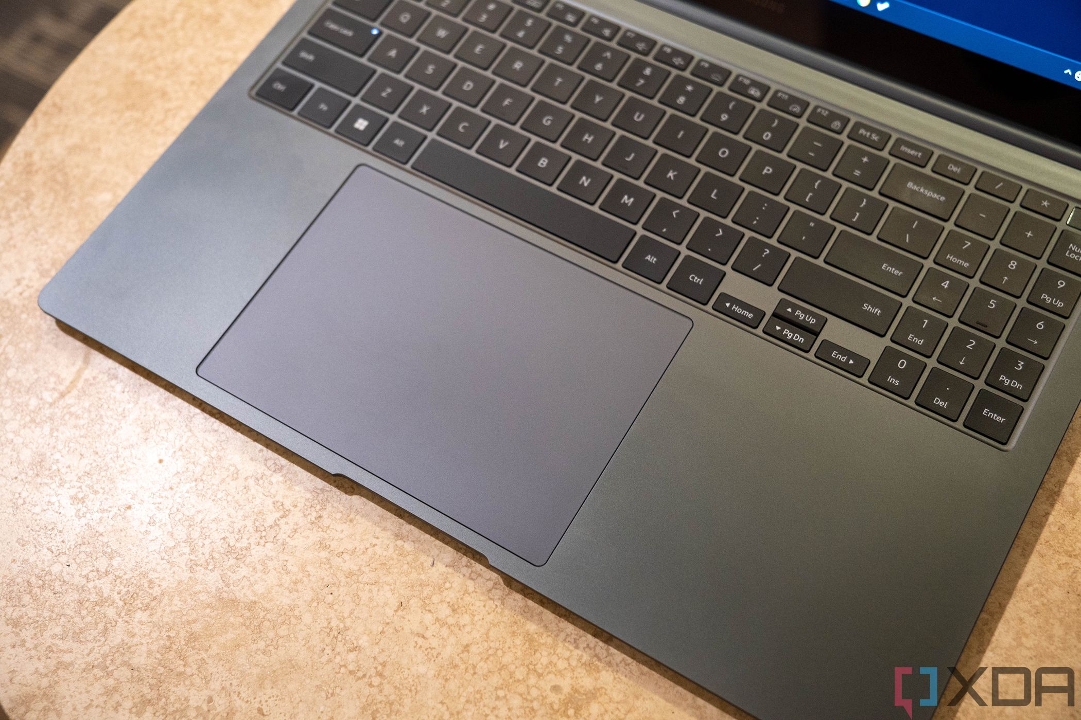 Angled view of giant touchpad on laptop keyboard