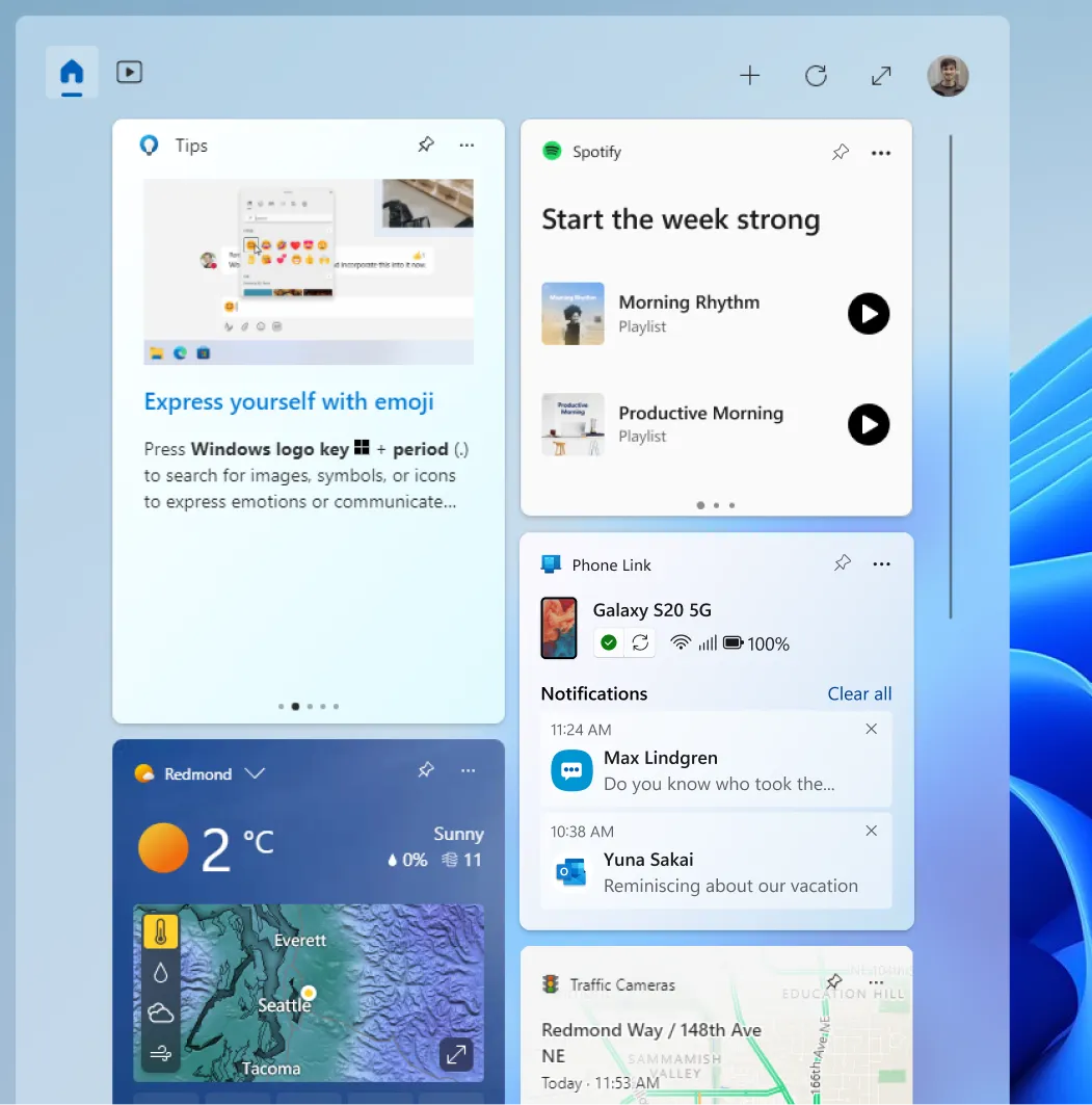 Una captura de pantalla del panel Widgets de Windows 11 con los widgets de Spotify y Phone Link