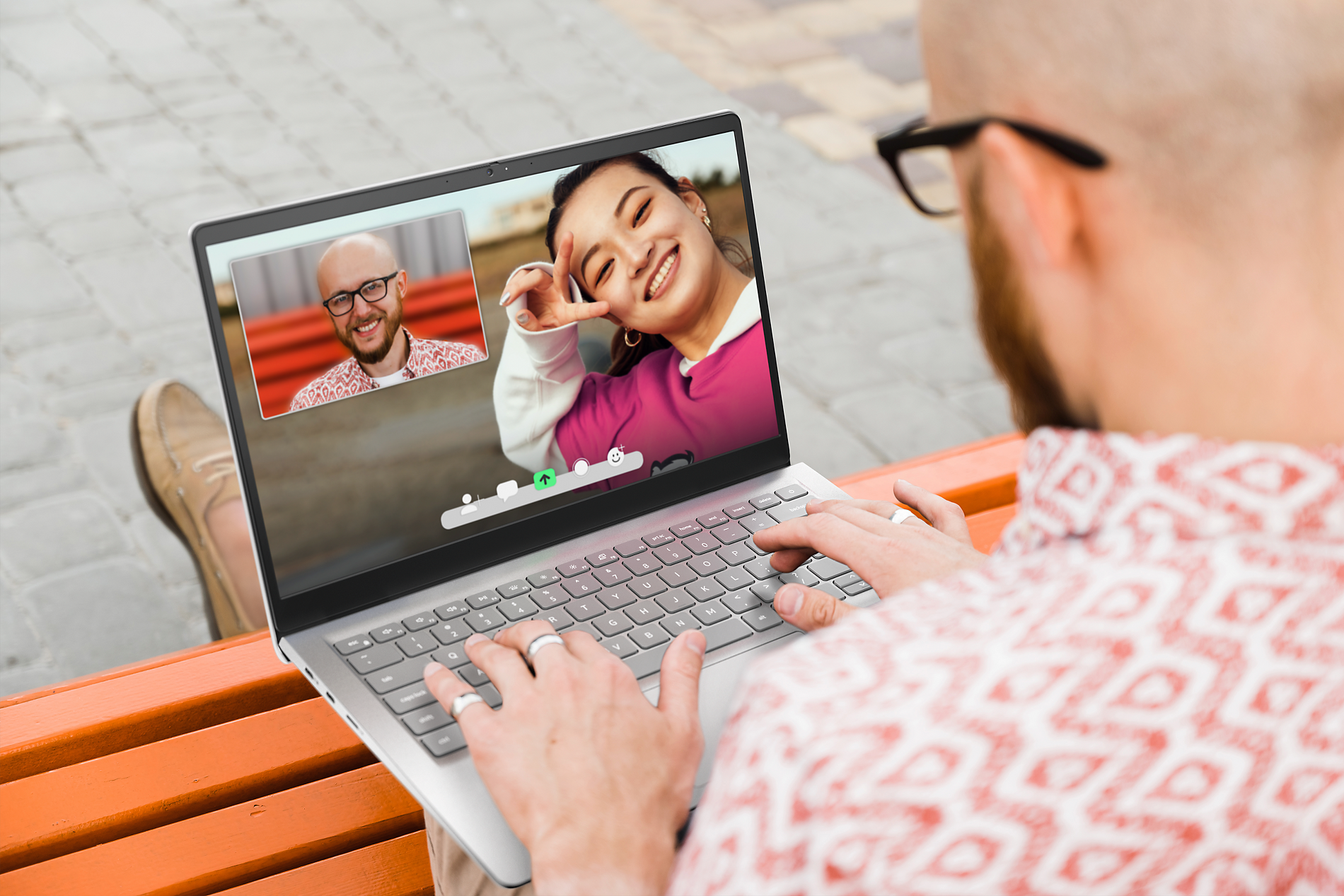 A man using laptop to make a video call with a woman, who is visible on the screen