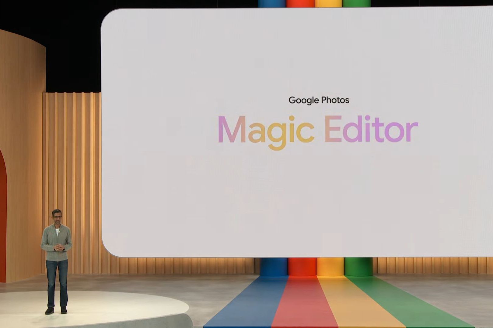 Google's Sundar Pichai at I/O 2023 next to a screen with text saying Google Photos Magic Editor.