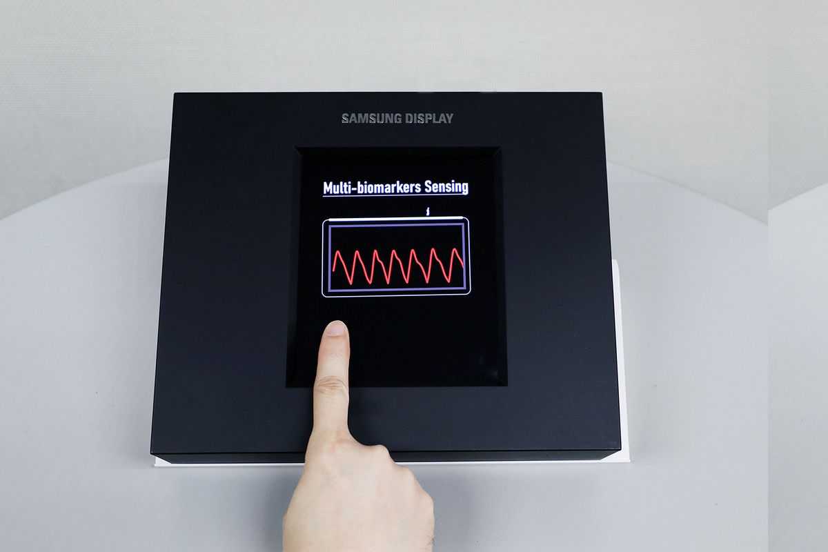 A forefinger touching the Samsung Sensor OLED Display to take biometric readings