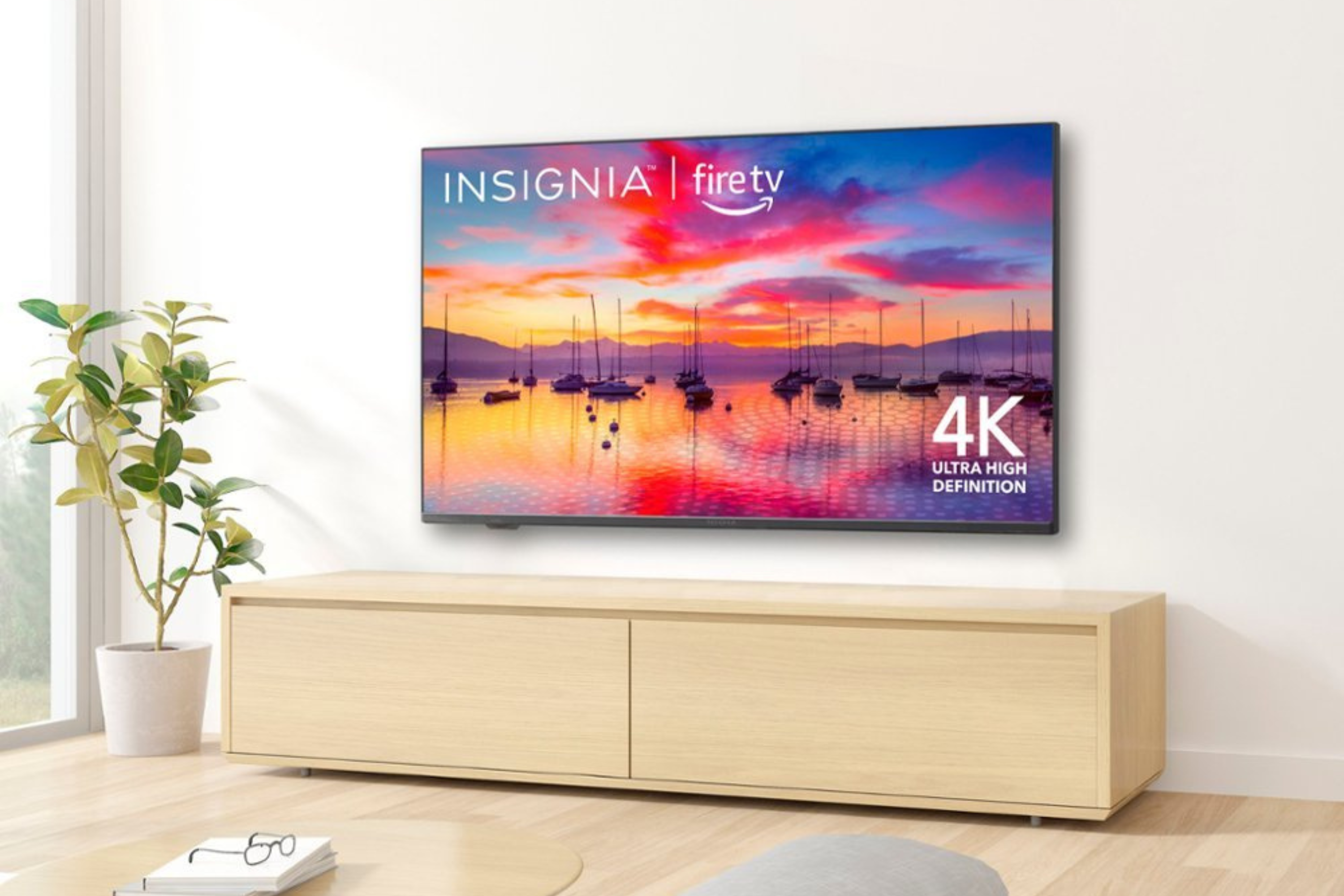 Insignia TV mounted to the wall with vibrant display in brightly lit room