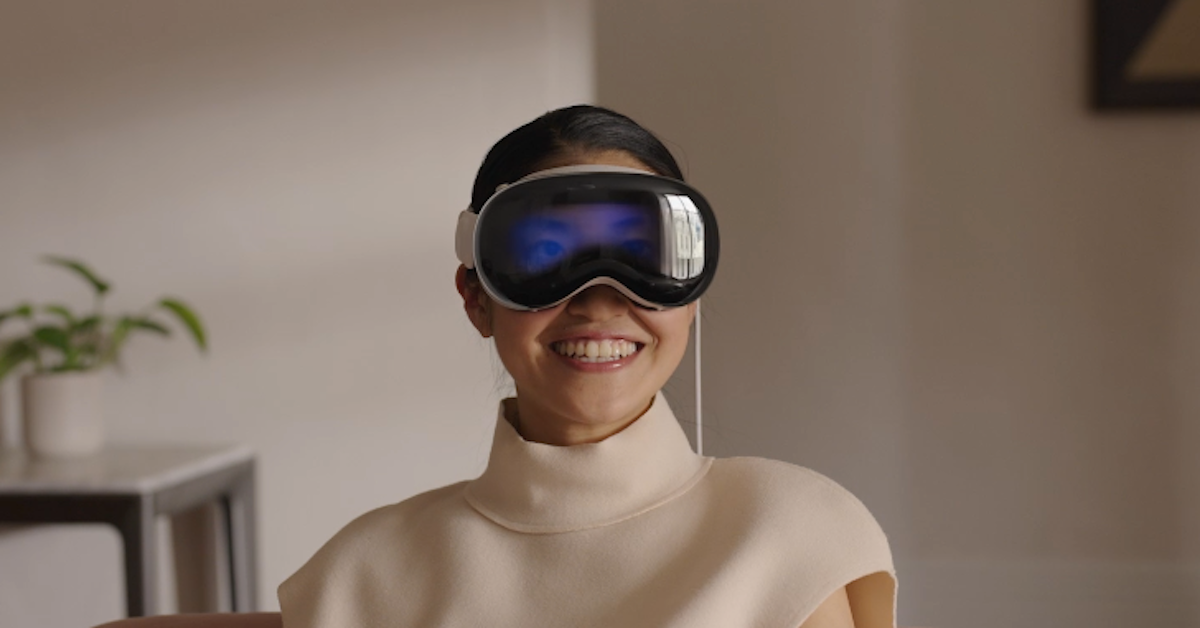 Ein Bild, das eine Person zeigt, die das Vision Pro-Headset von Apple trägt.