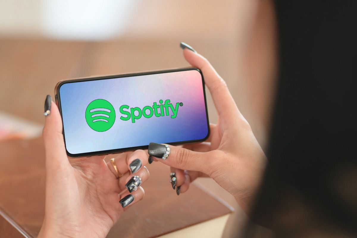 Spotify logo on a smartphone in the hands of a woman