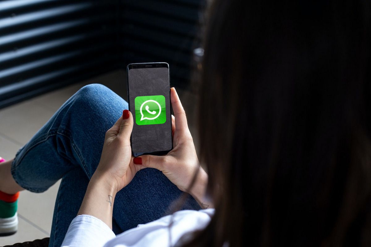 WhatsApp logo on an Android phone in a woman's hand