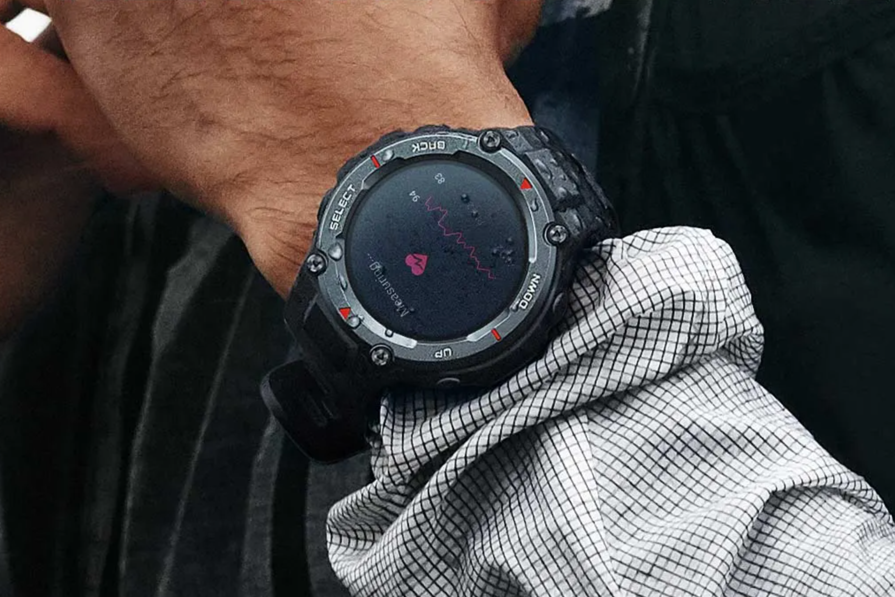 Amazfit T-Rex Pro on the wrist of person measuring with a mesh long sleeve on