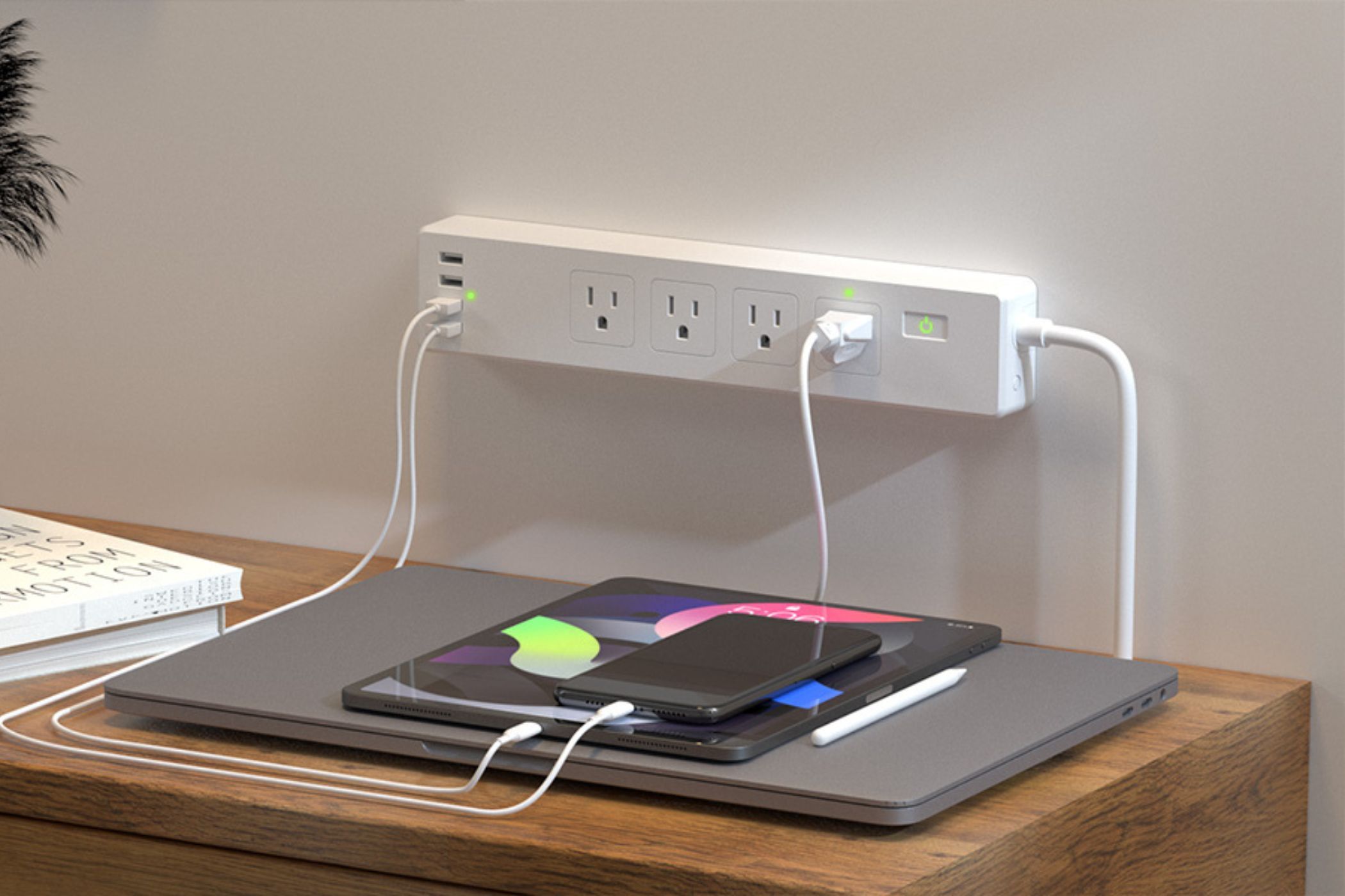 An showing the meross smart power strip mounted on a wall, charging a bunch of Apple products.