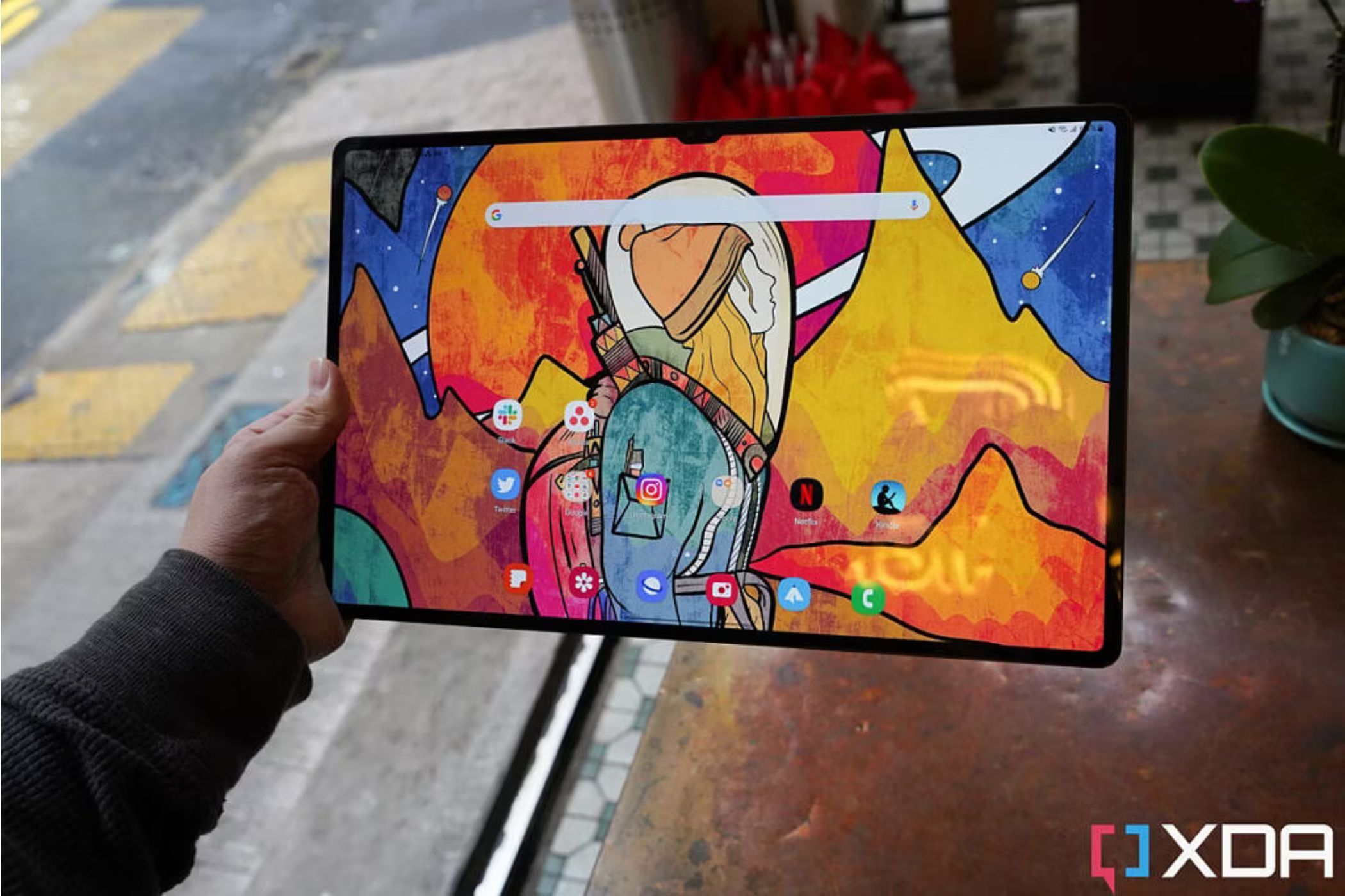 An image showing a person holding a Samsung Galaxy Tab S8 Ultra tablet.