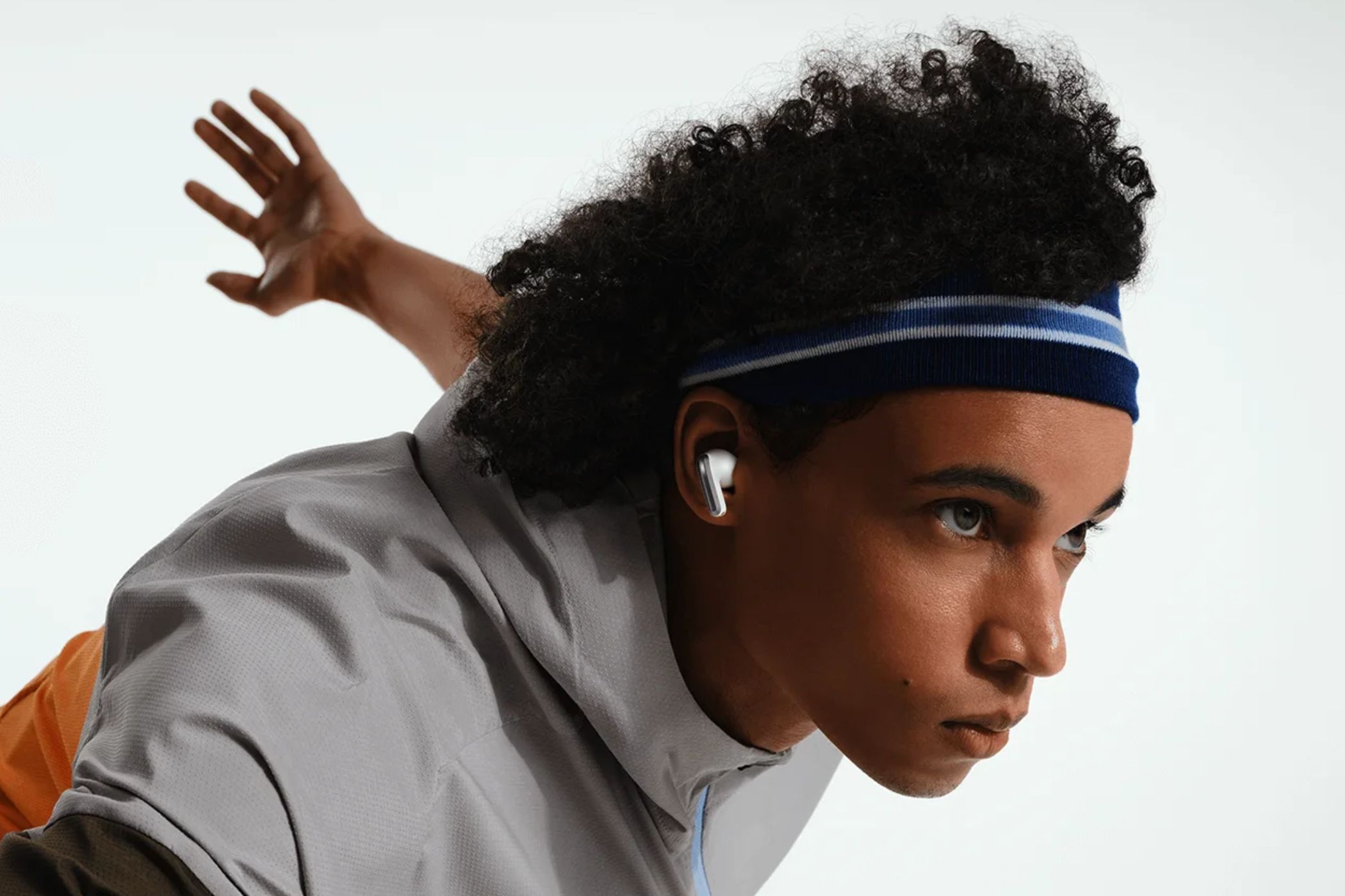 An image of a person wearing Xiaomi' Redmi Buds 4 Pro earbud in white color.