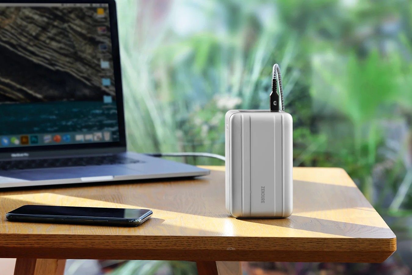 Zendure 100W SuperTank Pro power bank on a table next to a laptop