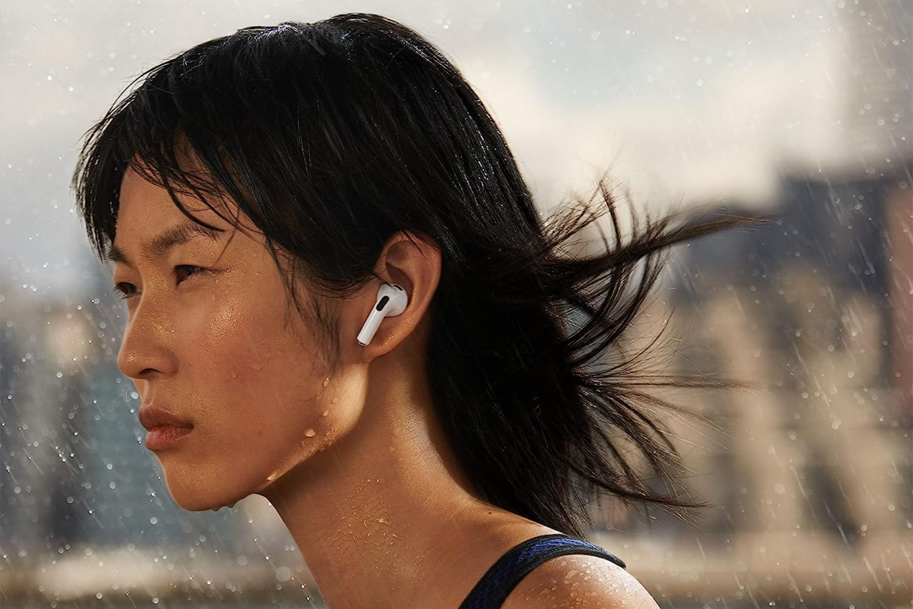 A woman wearing AirPods 3.