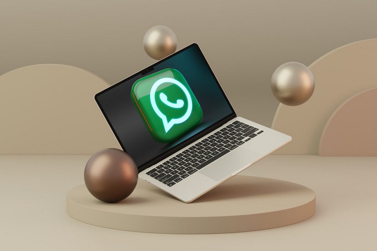 WhatsApp logo on MacBook Air on a beige background