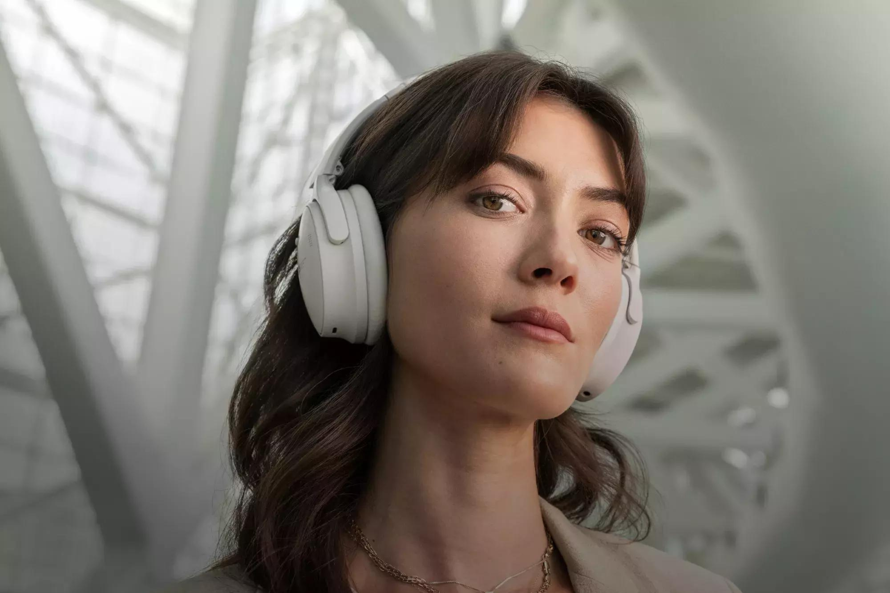 Bose QuietComfort 45 Headphones on the head of a person looking directly at the camera