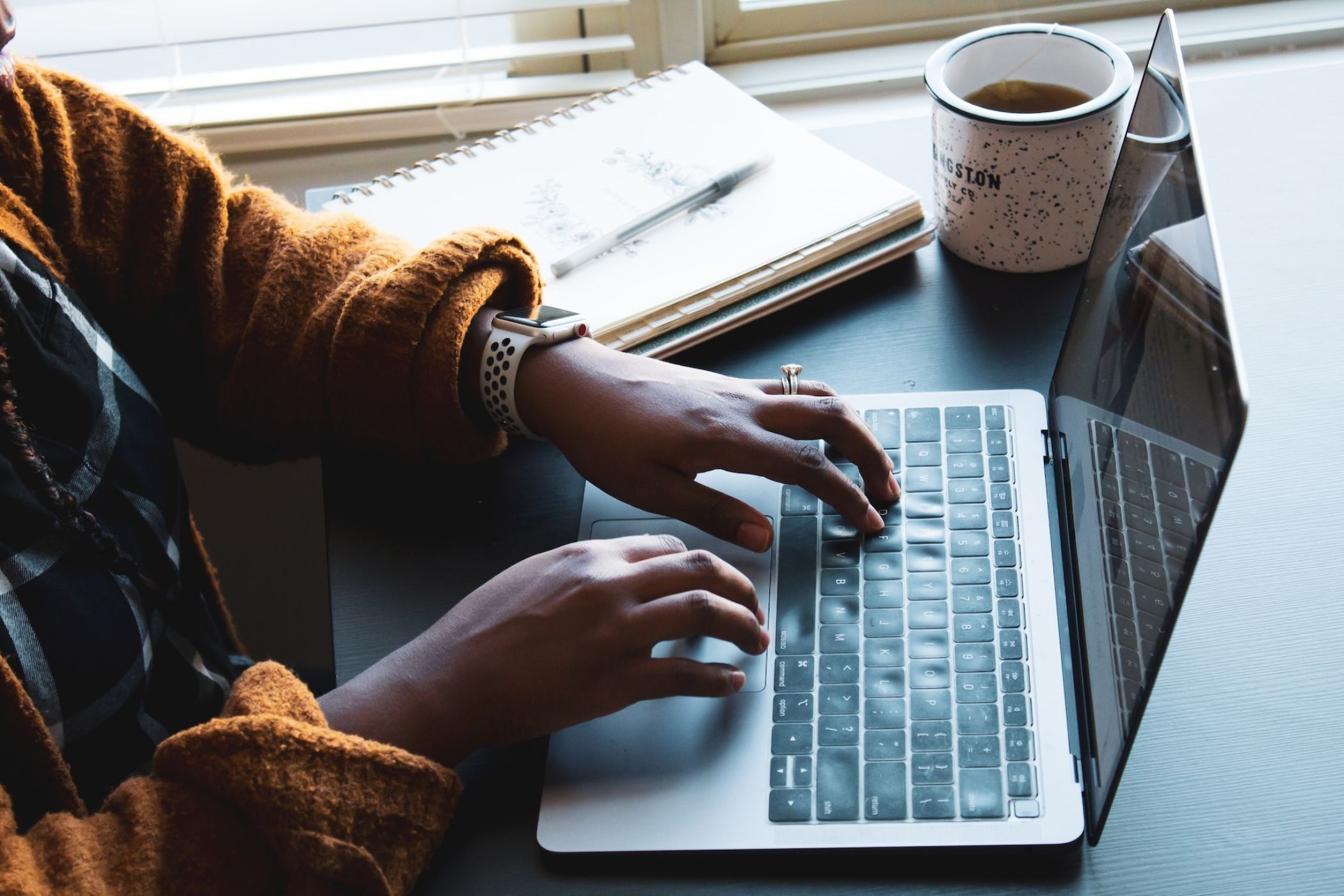 Woman typing on a macbook