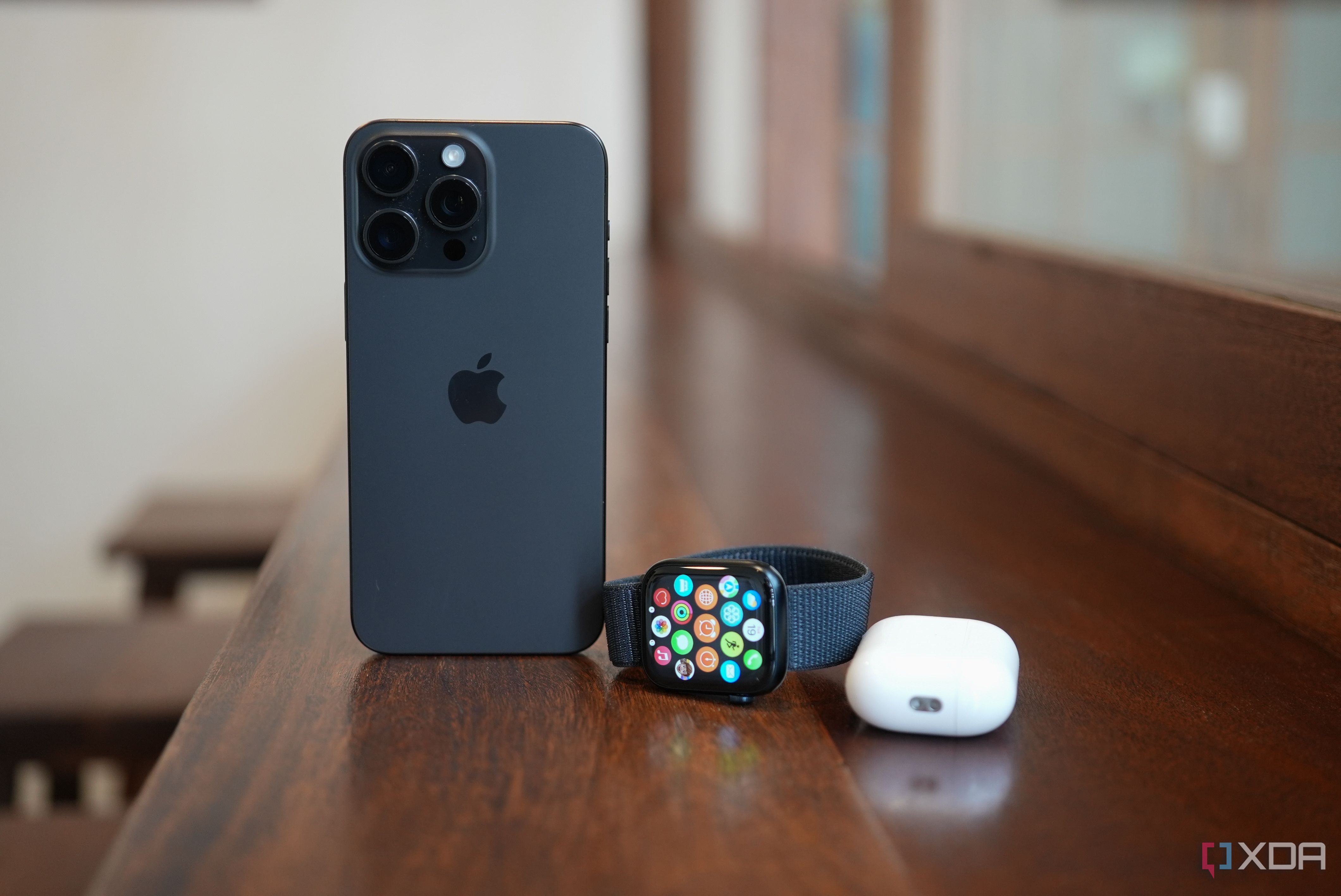 Apple Watch Series 9 next to an iPhone and AirPods Pro 2 case