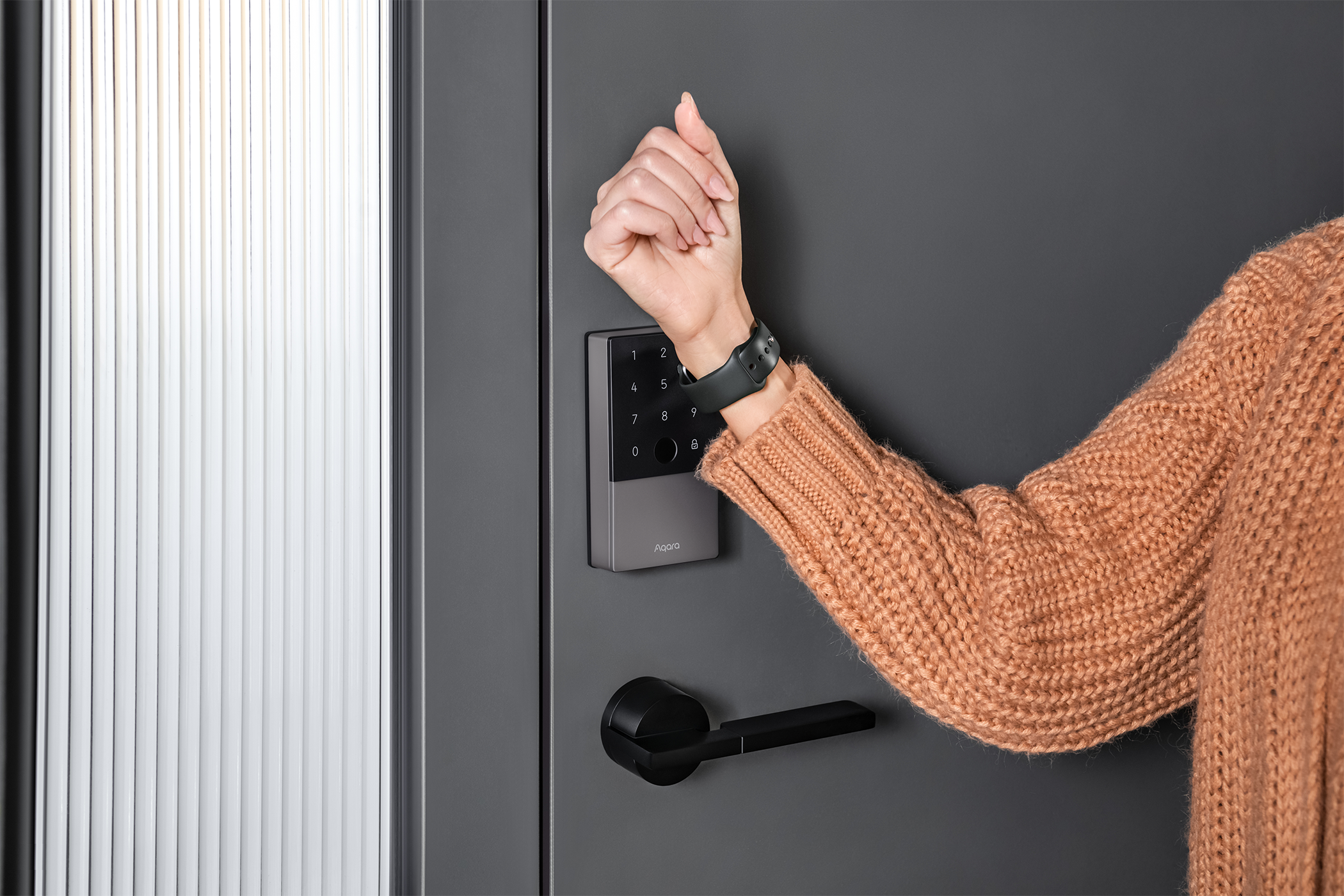 A woman opens her smart lock using her Apple Watch