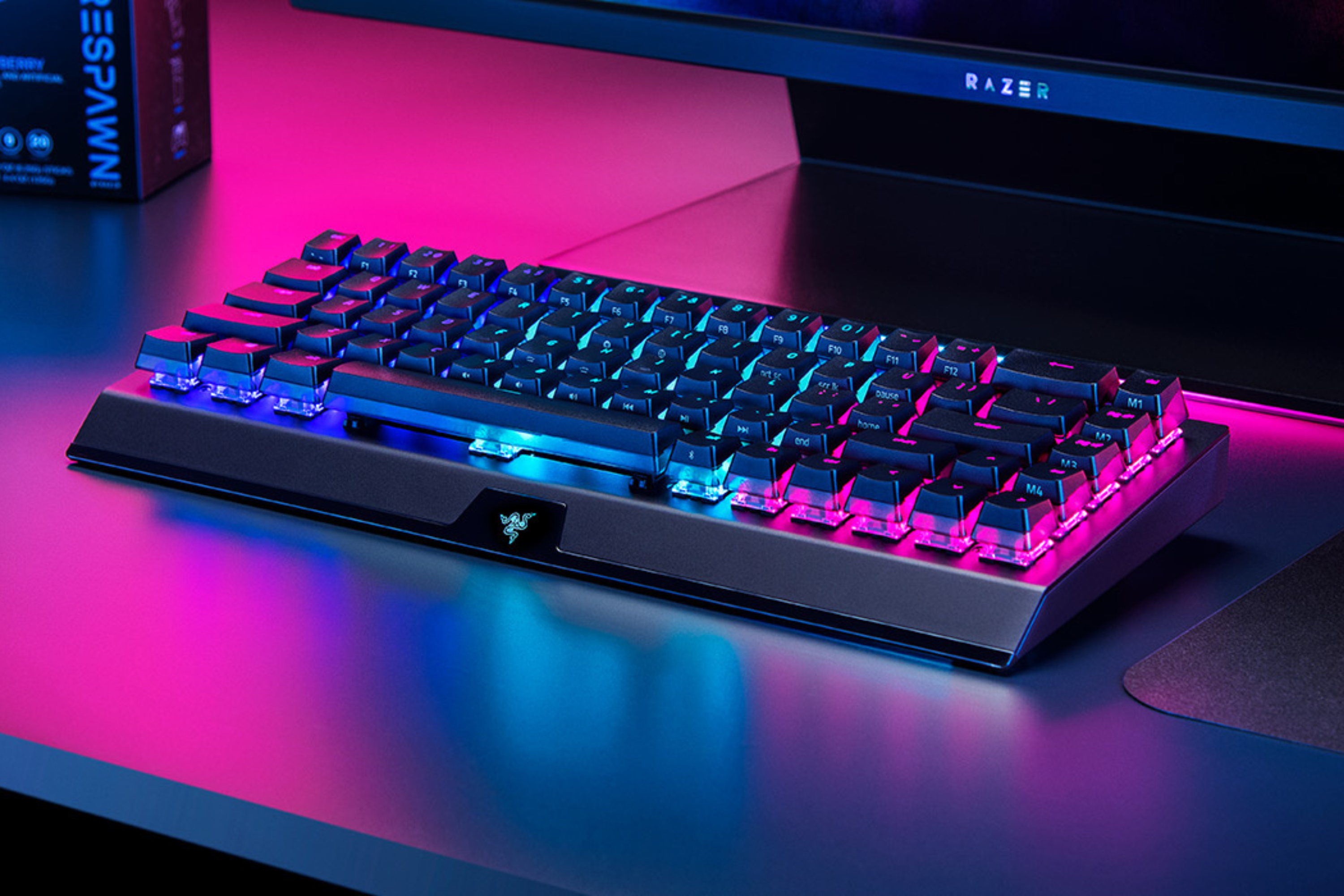 BlackWidow V3 Mini on desk with lots of neon lights 
