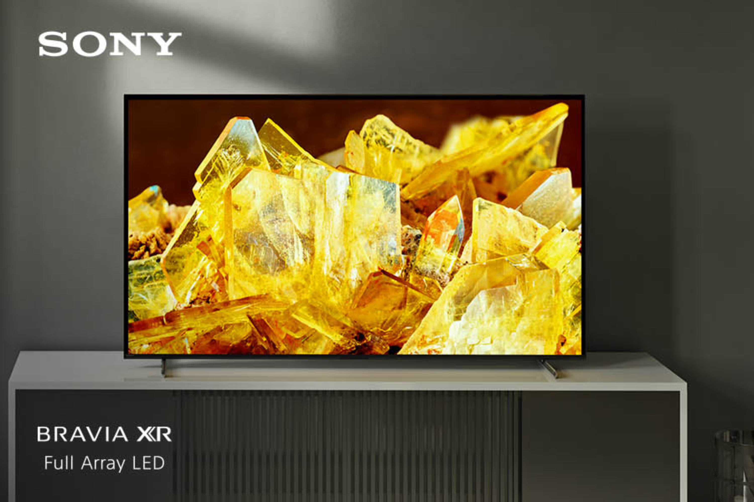Sony  X90L TV  on stand with yellow crystals on the screen 