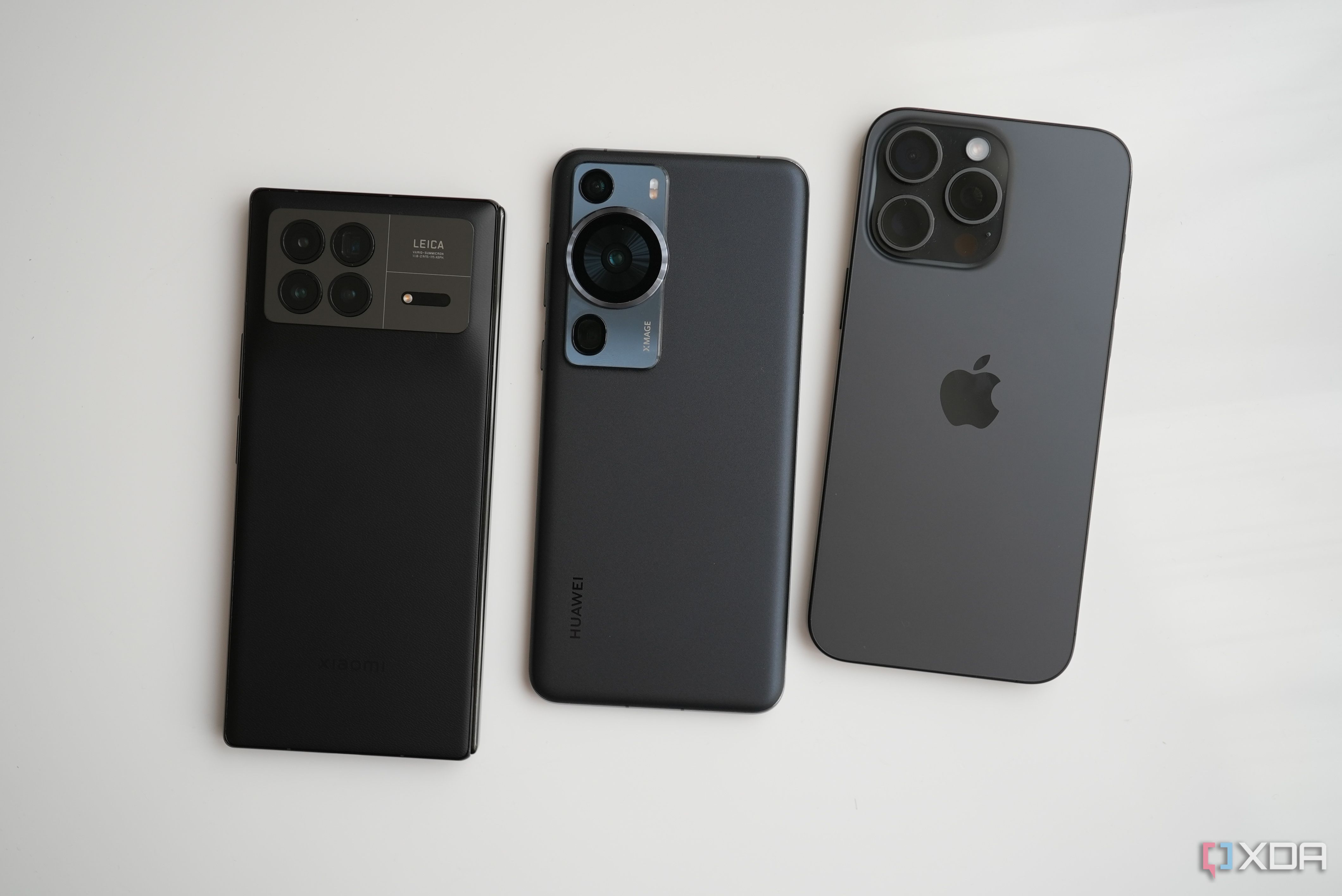 The iPhone 15 Pro Max (right) with the Huawei P60 Pro (middle) and Xiaomi Mix Fold 3 (left). 