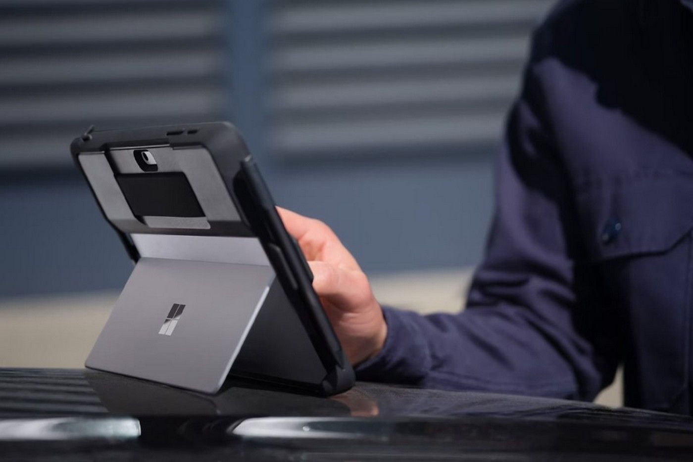A model using the Surface Go 4 for Business with a protective case cover