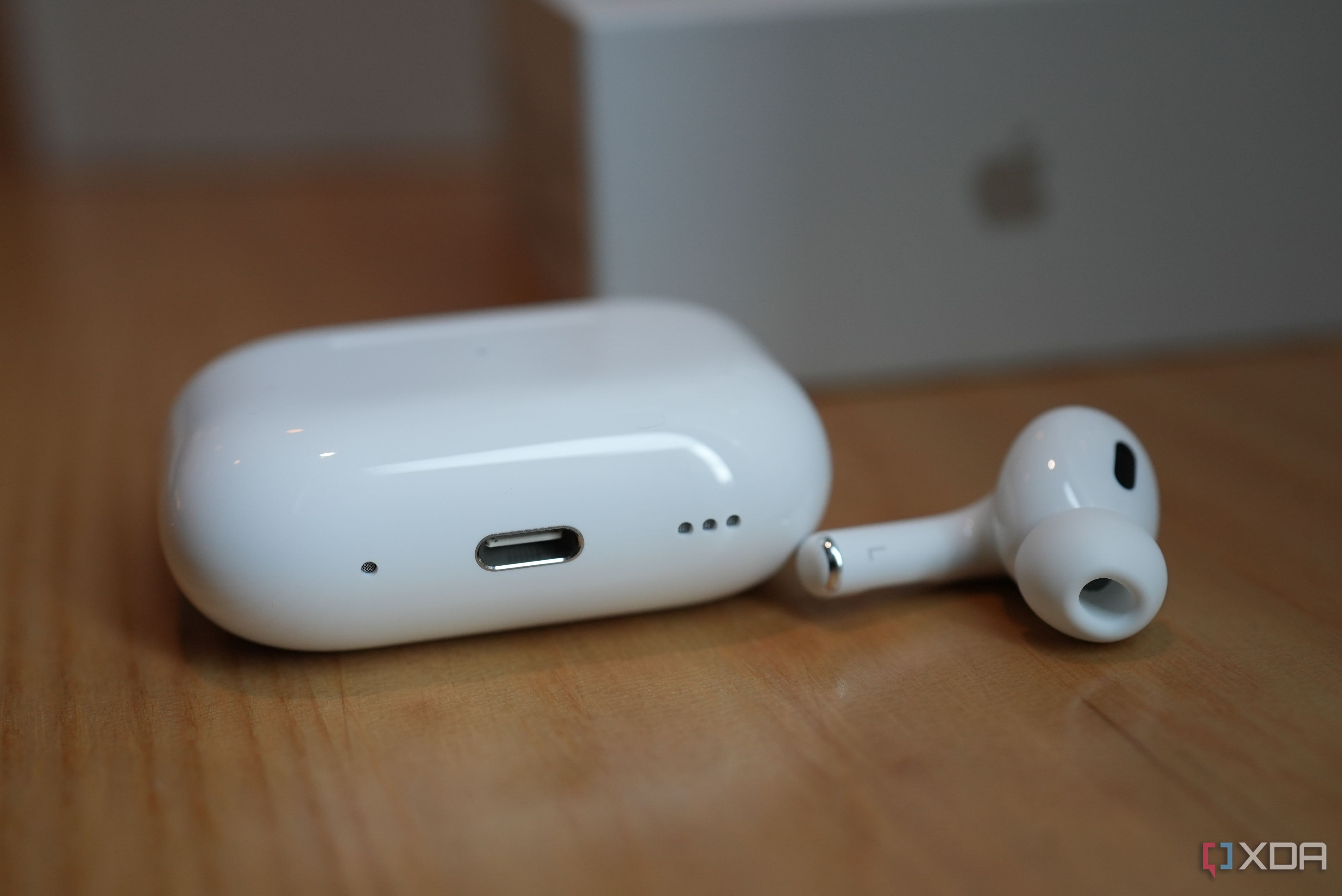 AirPods Pro 2 placed on a table with one earbud outside the case