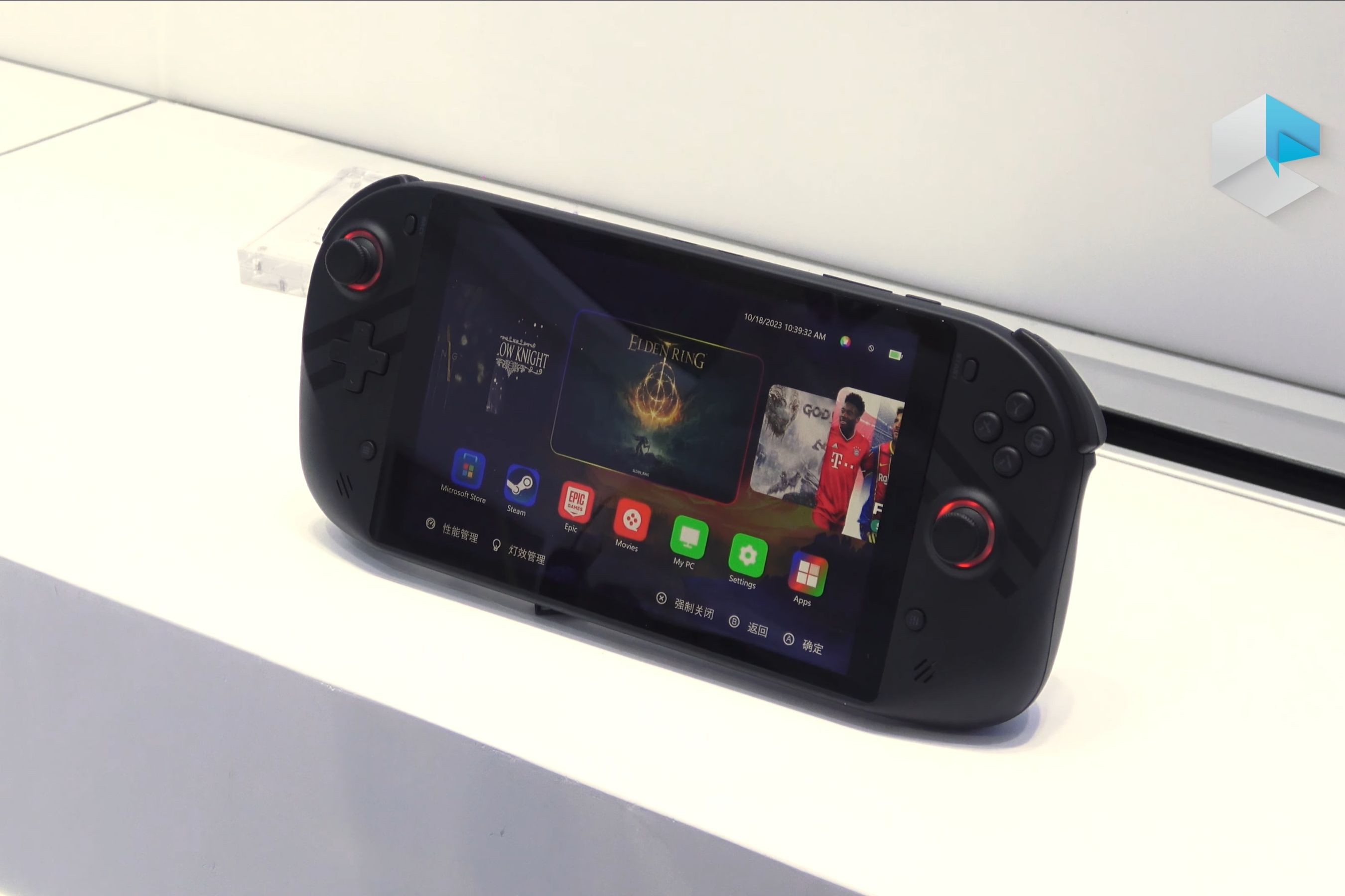 A handheld gaming PC standing up and displaying a menu with multiple games