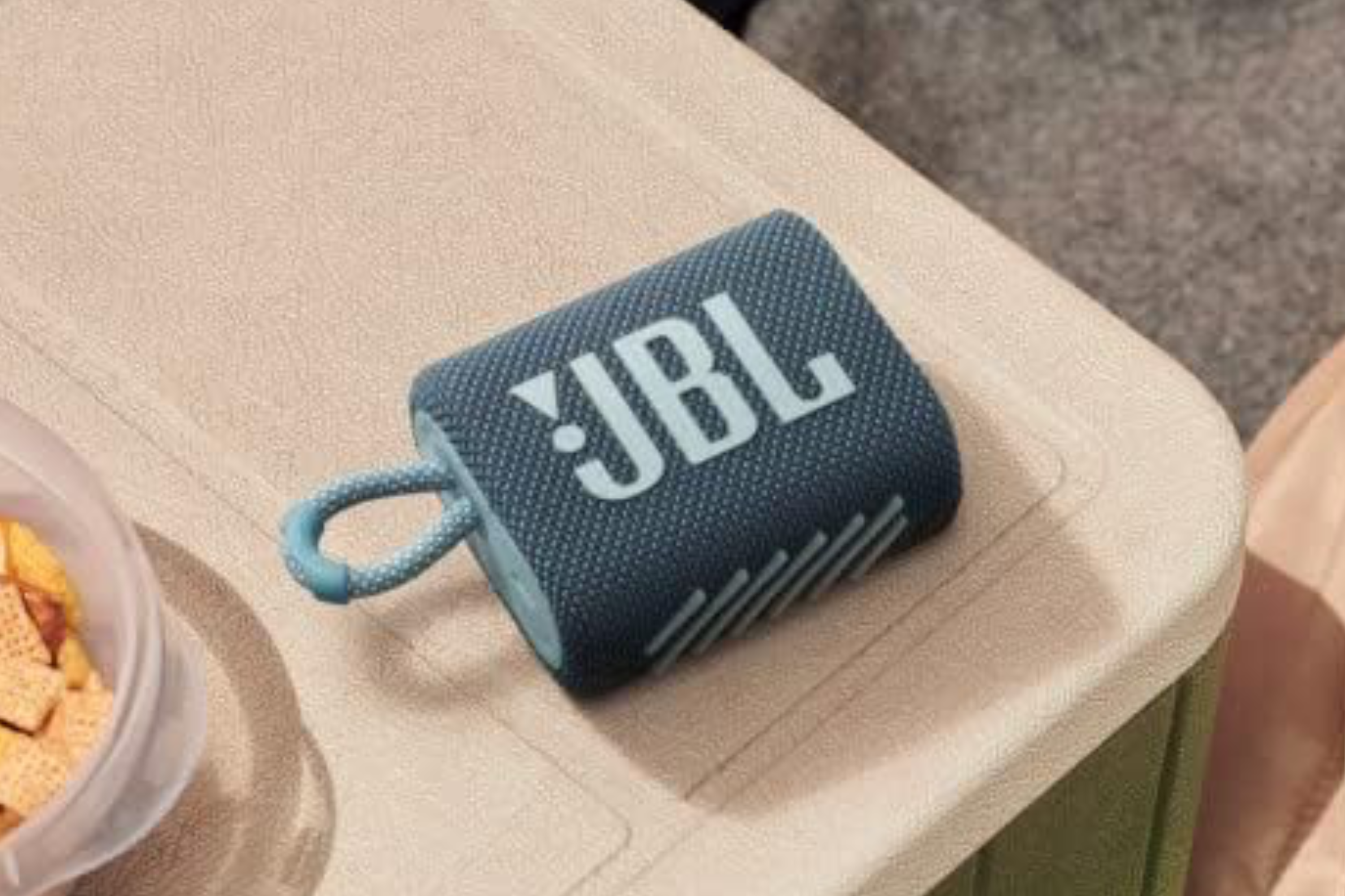 A blue JBL Go 3 on a water cooler.