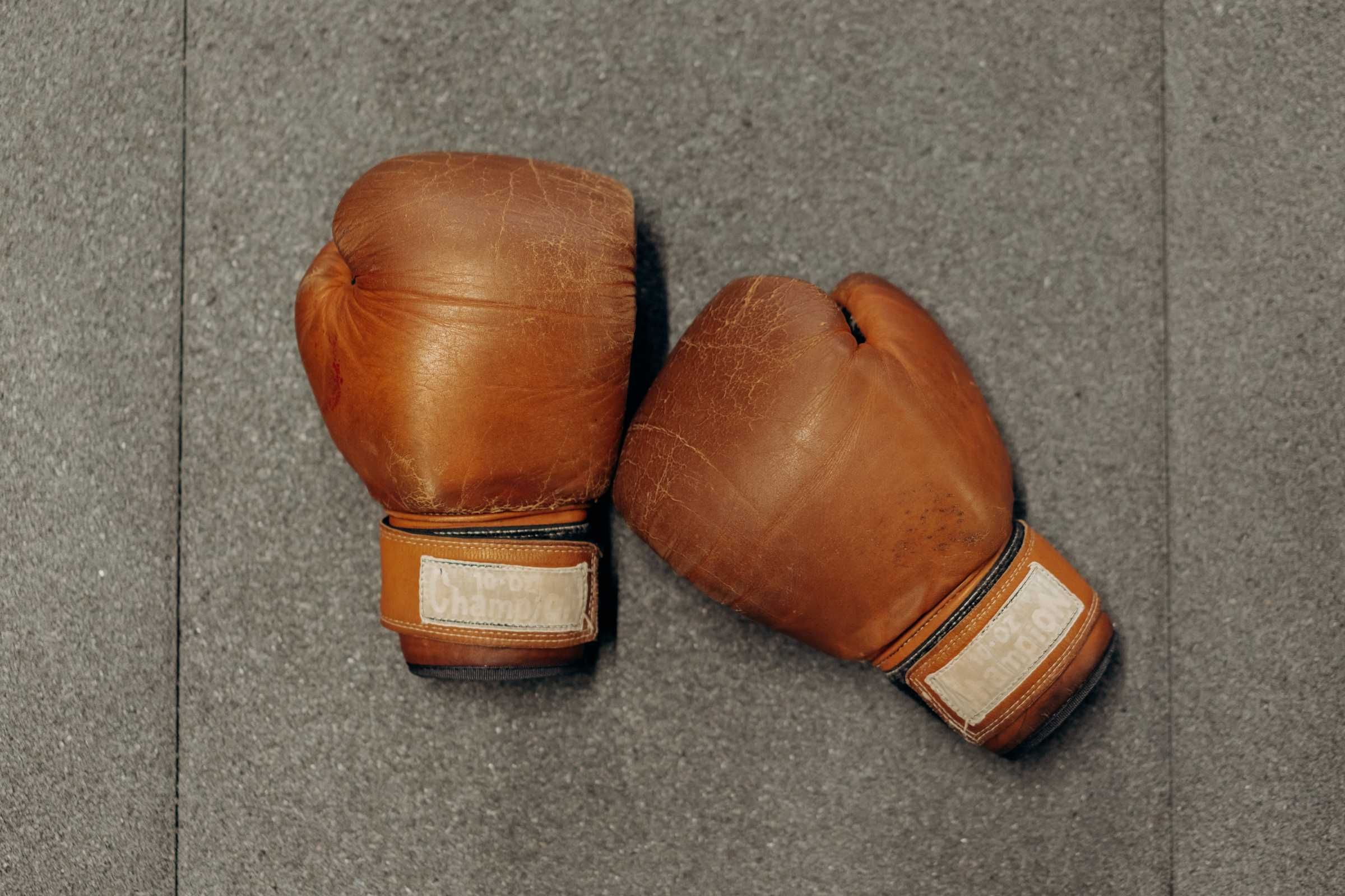 pair of well-used boxing gloves on the floor